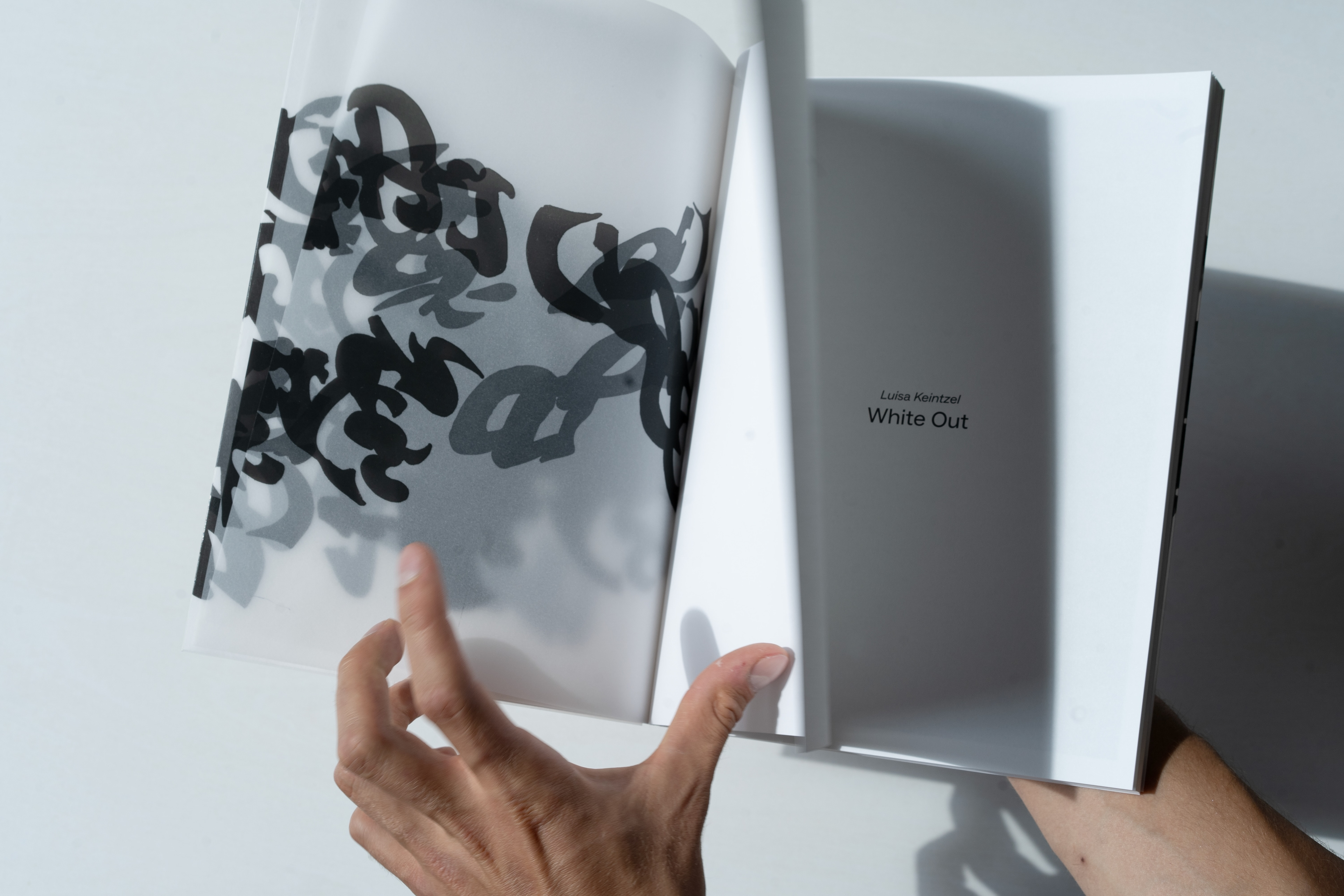 repro book- asemic writing as intro and outro of the book printed on transparent paper