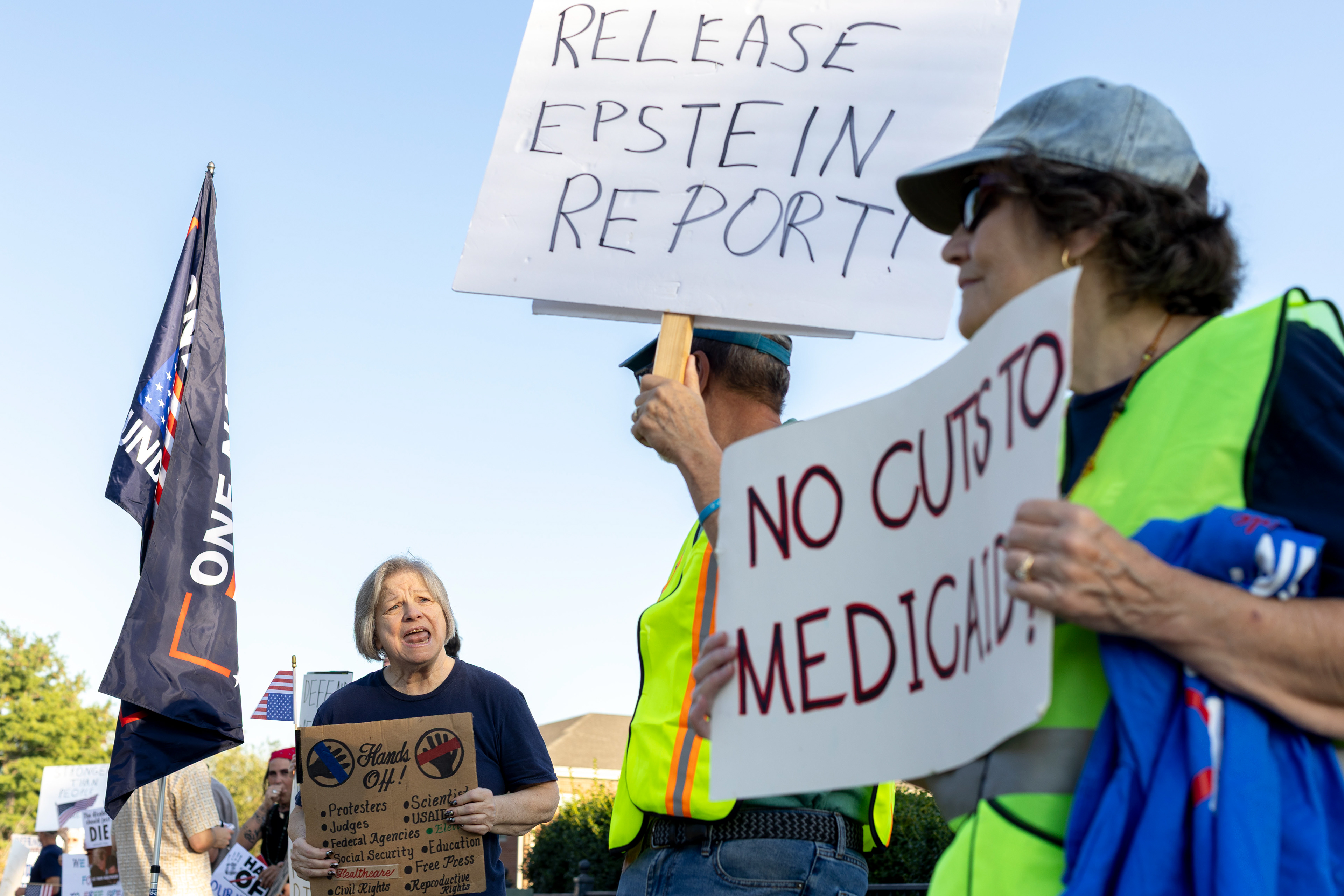 Claudia Hanes dances and sings along to music playing at a protest held by SoKy Indivisible outside of U.S. Rep. Brett Guthrie’s office on Thursday, Oct. 2, 2025. 