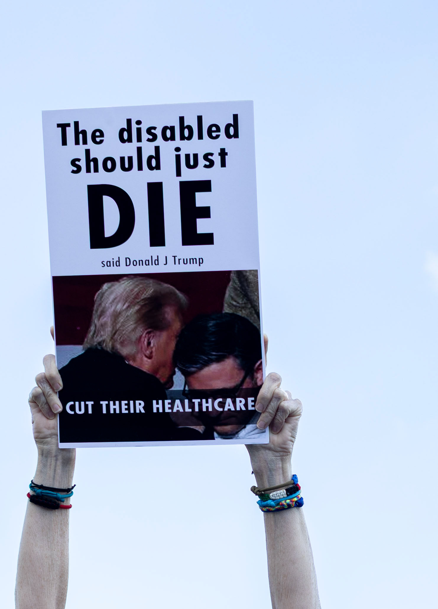 Sharon Campshure presents her sign to passing traffic at a protest held by SoKy Indivisible outside of U.S. Rep. Brett Guthrie’s office on Thursday, Oct. 2, 2025. 