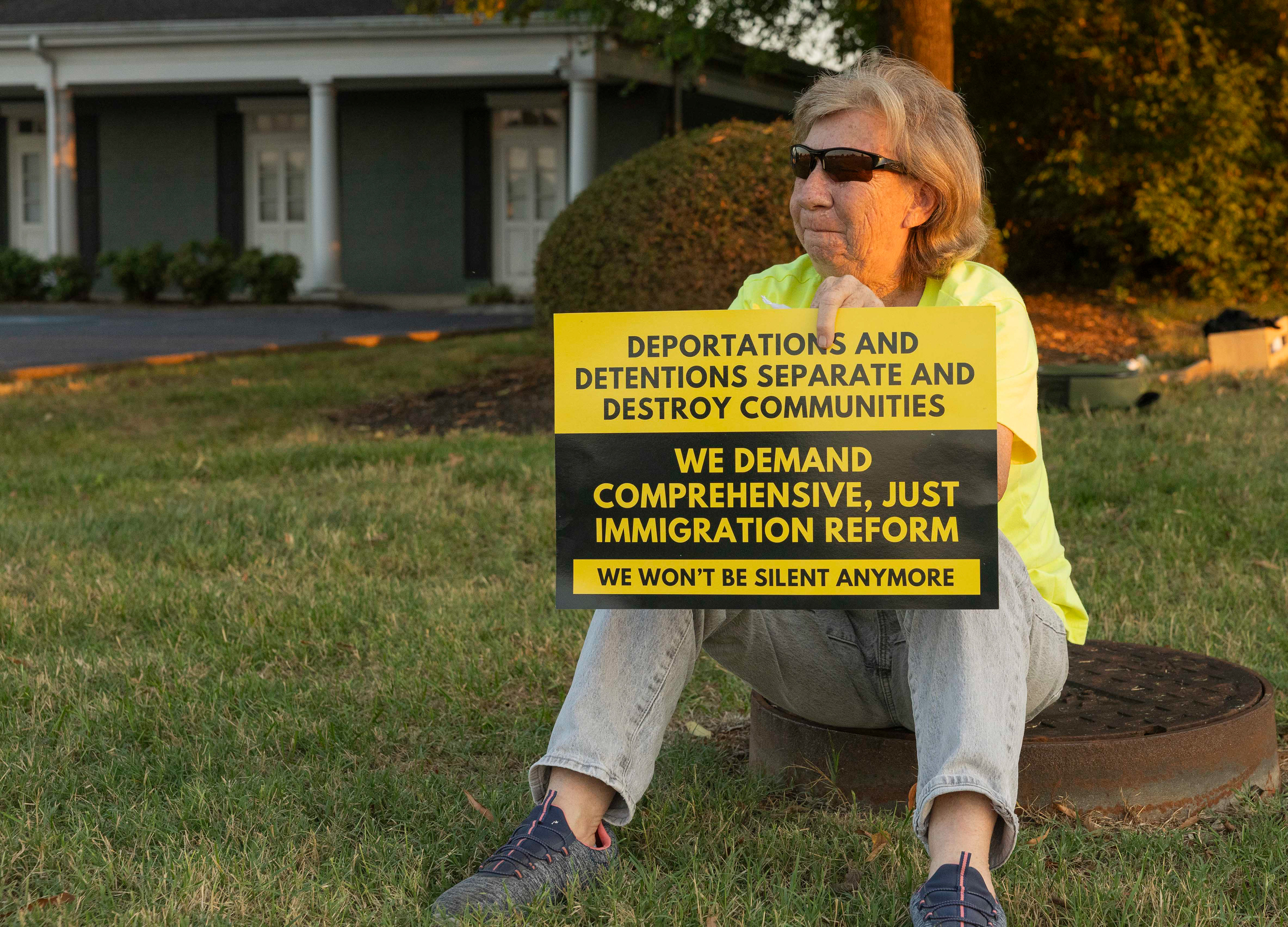Del Hudson distances herself from the crowd while smoking a cigarette at the ICE victim candlelight vigil on Monday, Sept. 15, 2025 outside of ICE Headquarters in Bowling Green. 