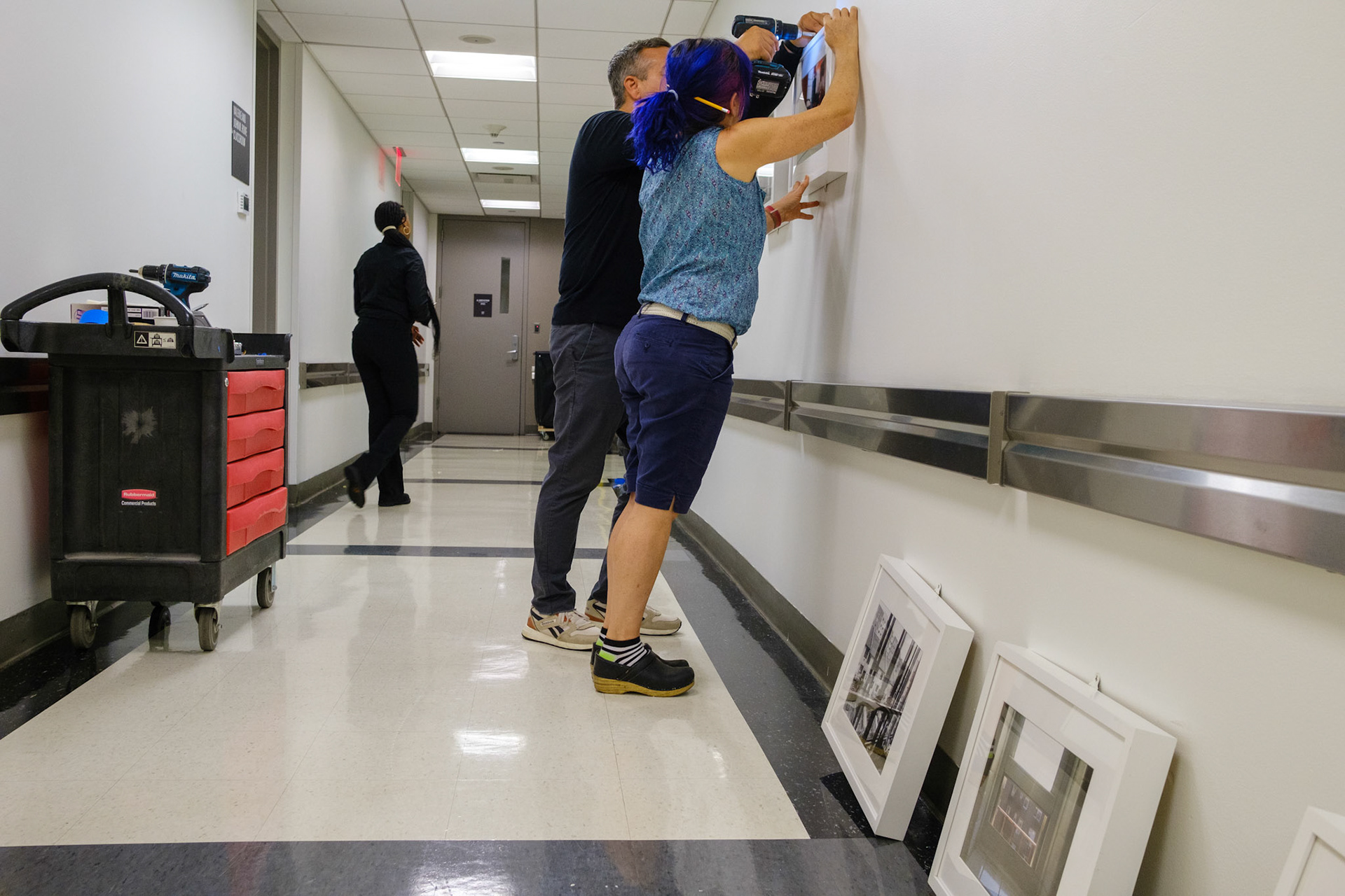 Exhibitions team mounting the youth curated images.