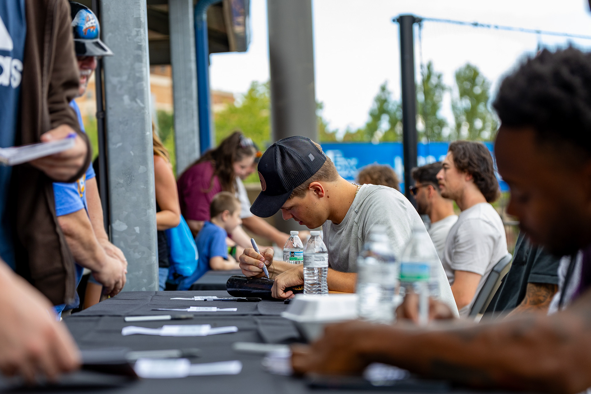 Milán Tolentino signs a bat at Canal Park on August 11 2024.