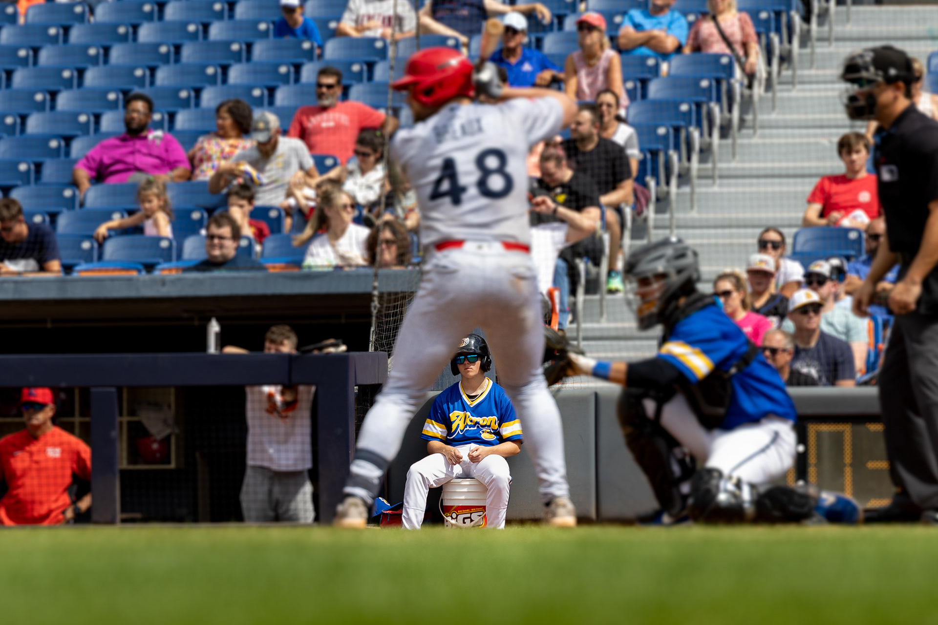 One of the ball boys at Canal Park sits on a bucket on August 11 2024.