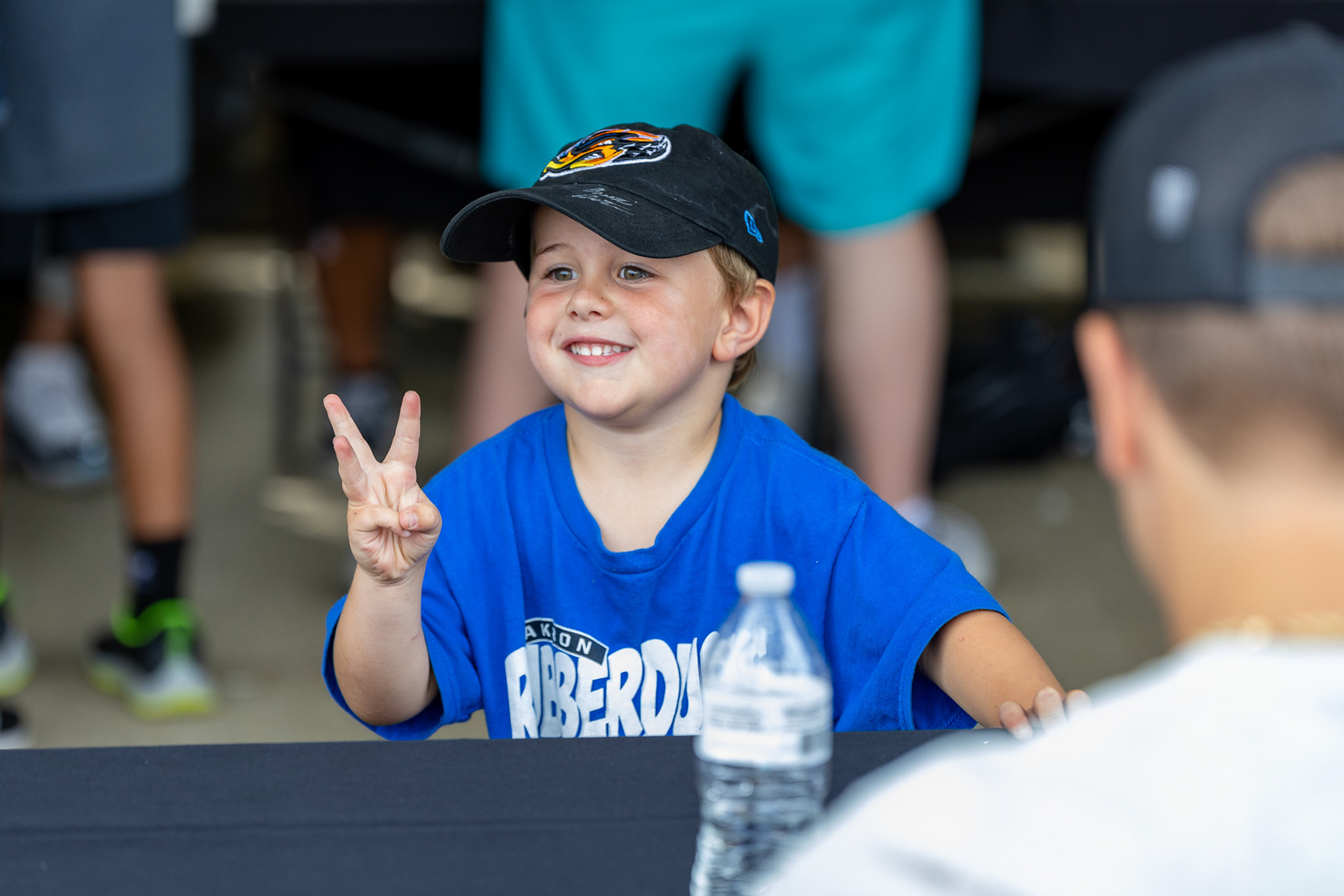 A kid shows the players how old he is using his fingers on August 11 2024.