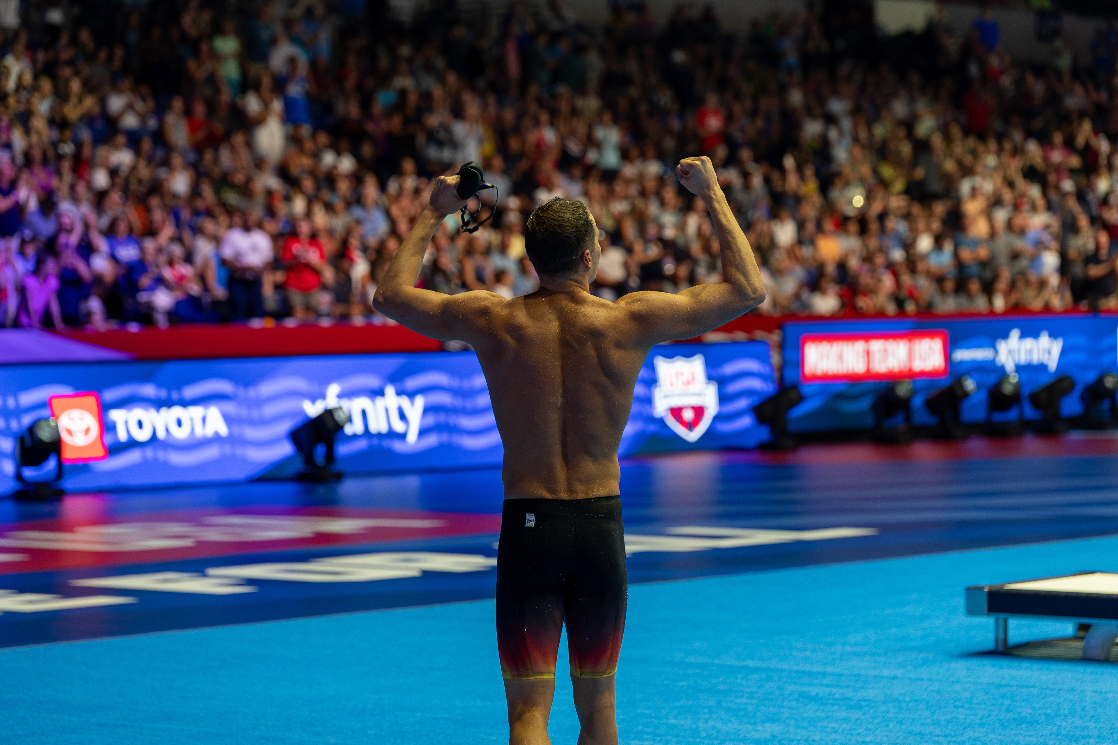 Nic Fink flexes after winning the 100 Breaststroke at the U.S. Olympic Swim Trials at Lucas Oil Stadium on June 16 2024.