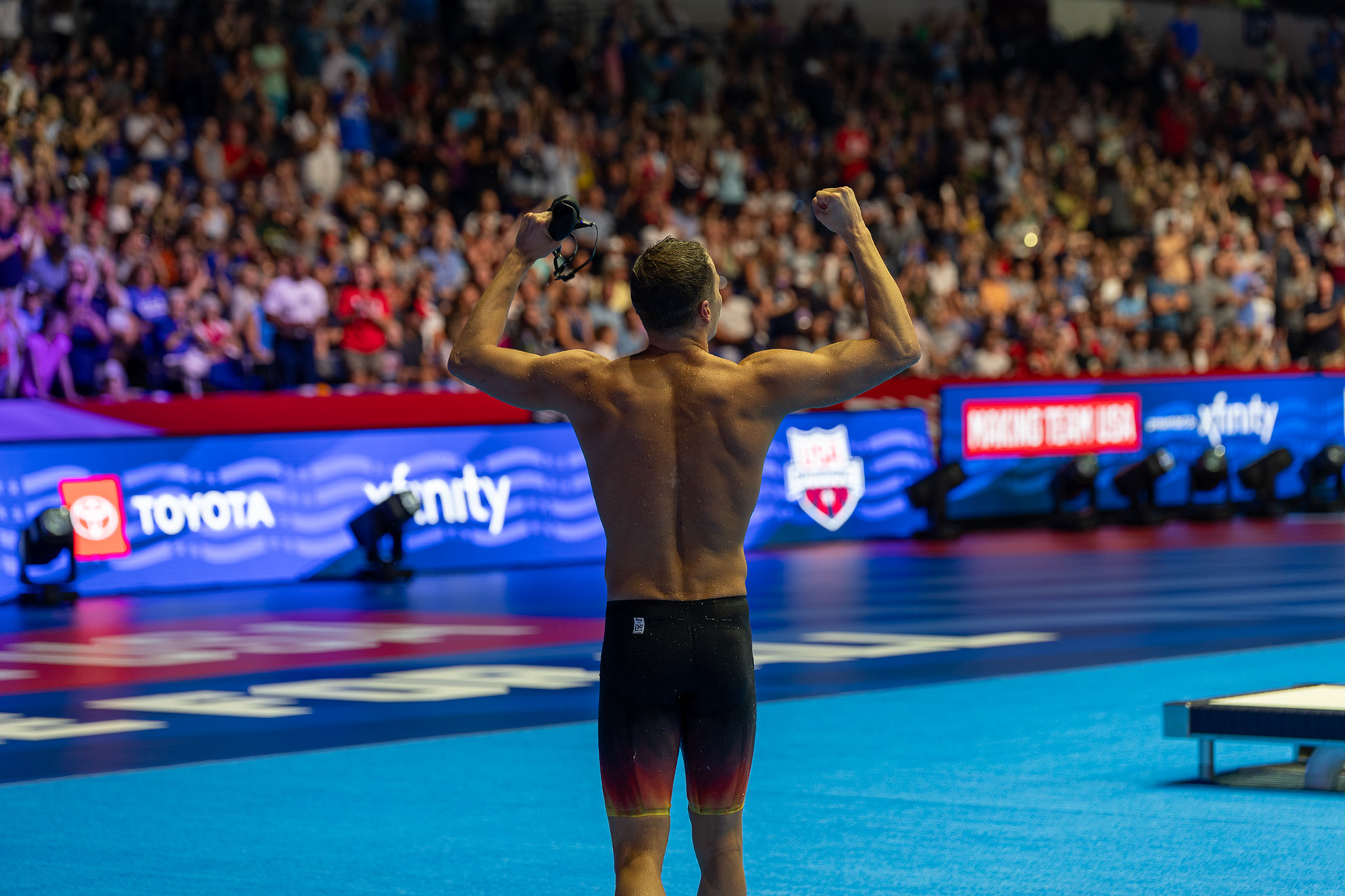 Nic Fink flexes after winning the 100 Breaststroke with a time of 59.08 at the U.S. Olympic Swim Trials at Lucas Oil Stadium on June 16 2024.
