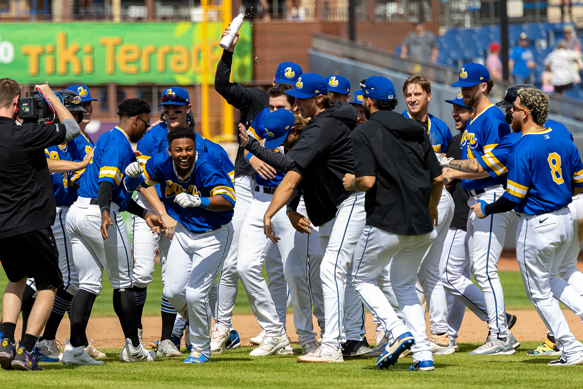 The Akron Rubberducks team celebrates on the field after a walk-off on August 11 2024.