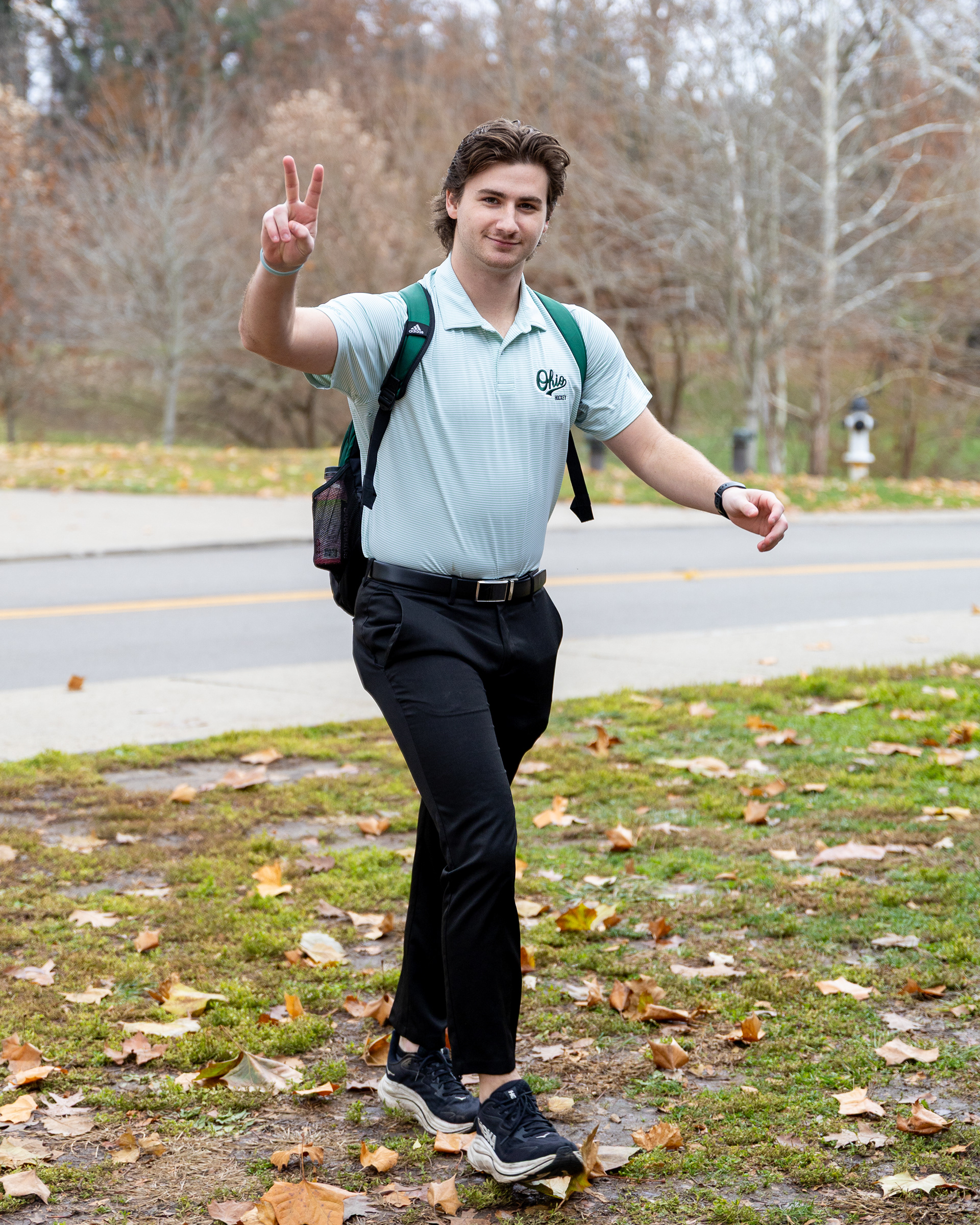 Ohio Bobcats Forward #19, Josh Folmer, poses for a photo as he walks into the rink before a game at Bird Ice Arena.