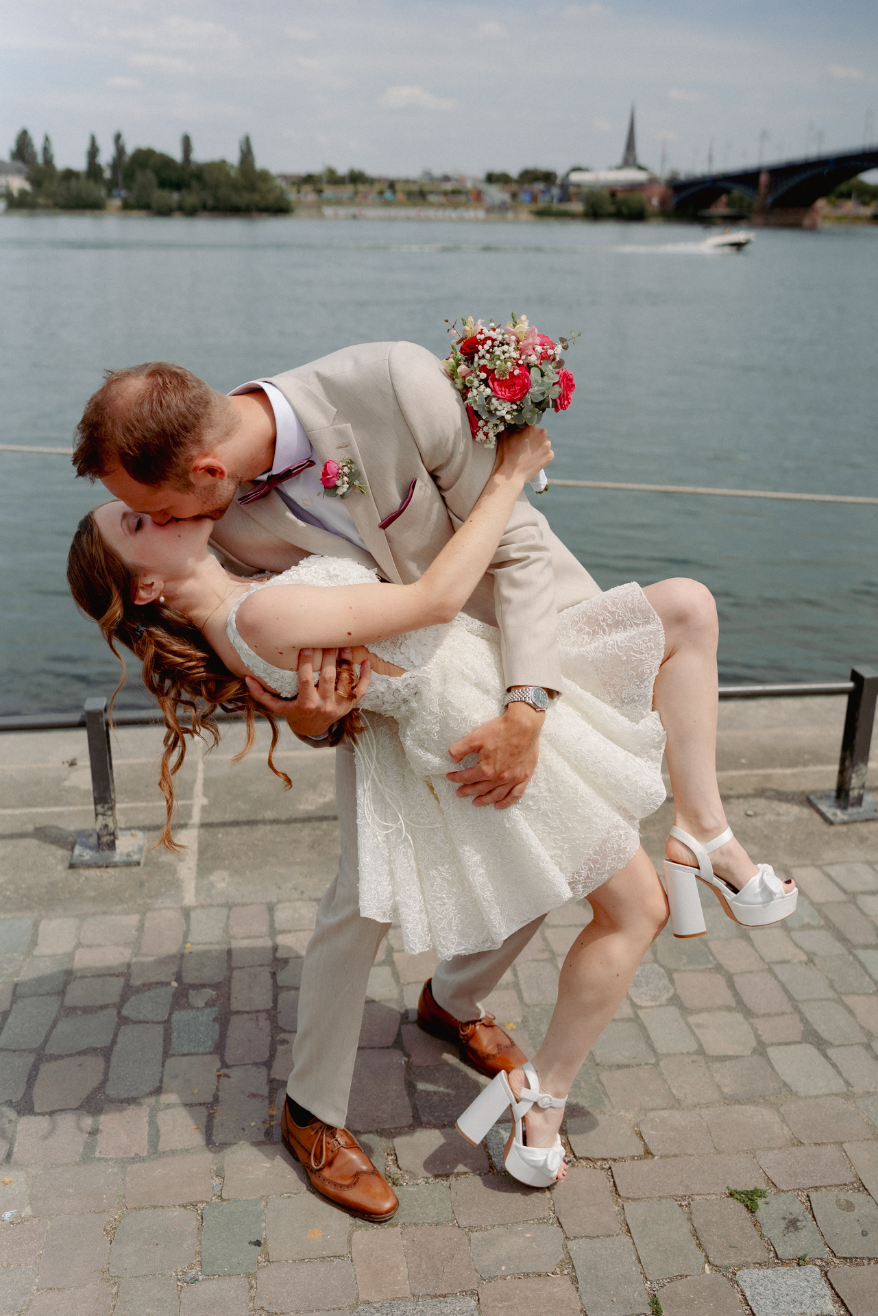 Hochzeitspaar küsst sich am Rhein