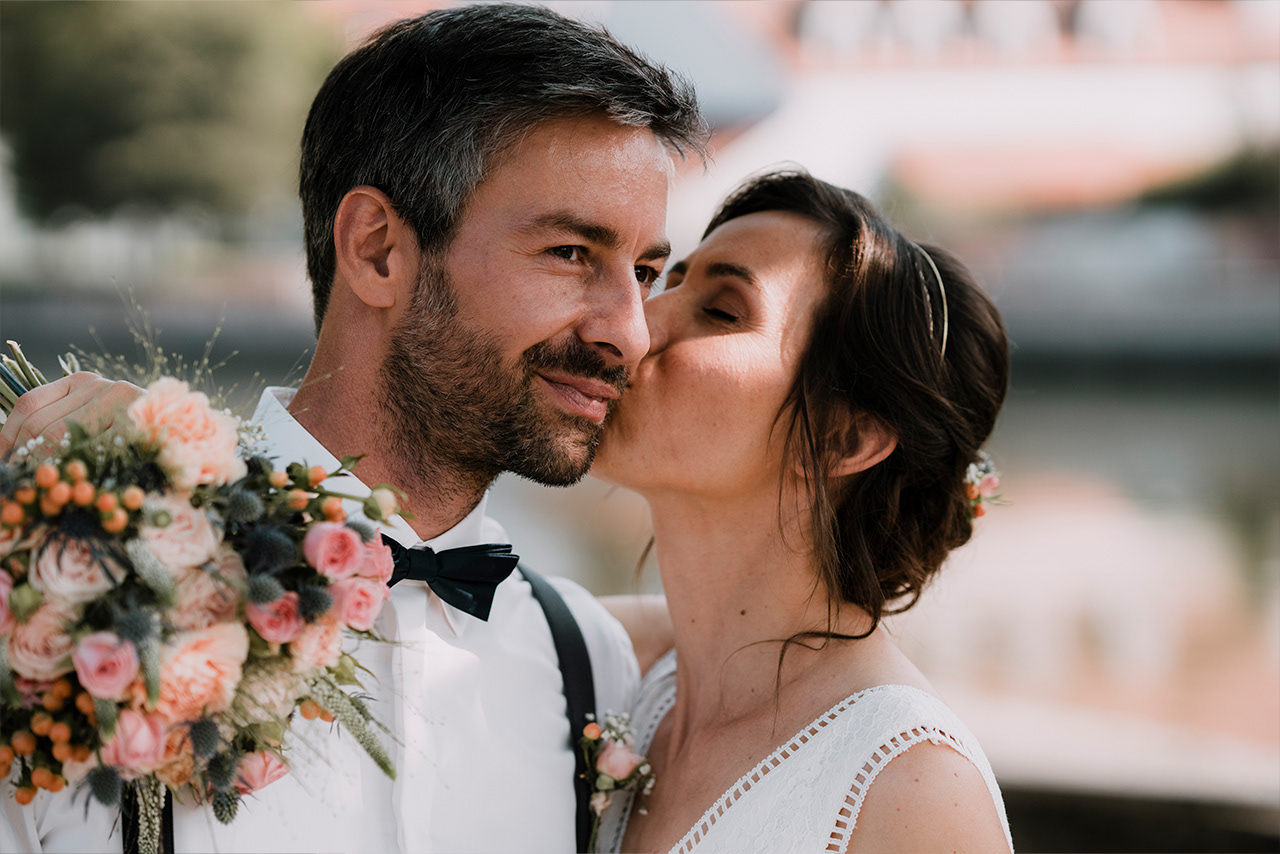 Braut küsst Bräutigam auf die Wange