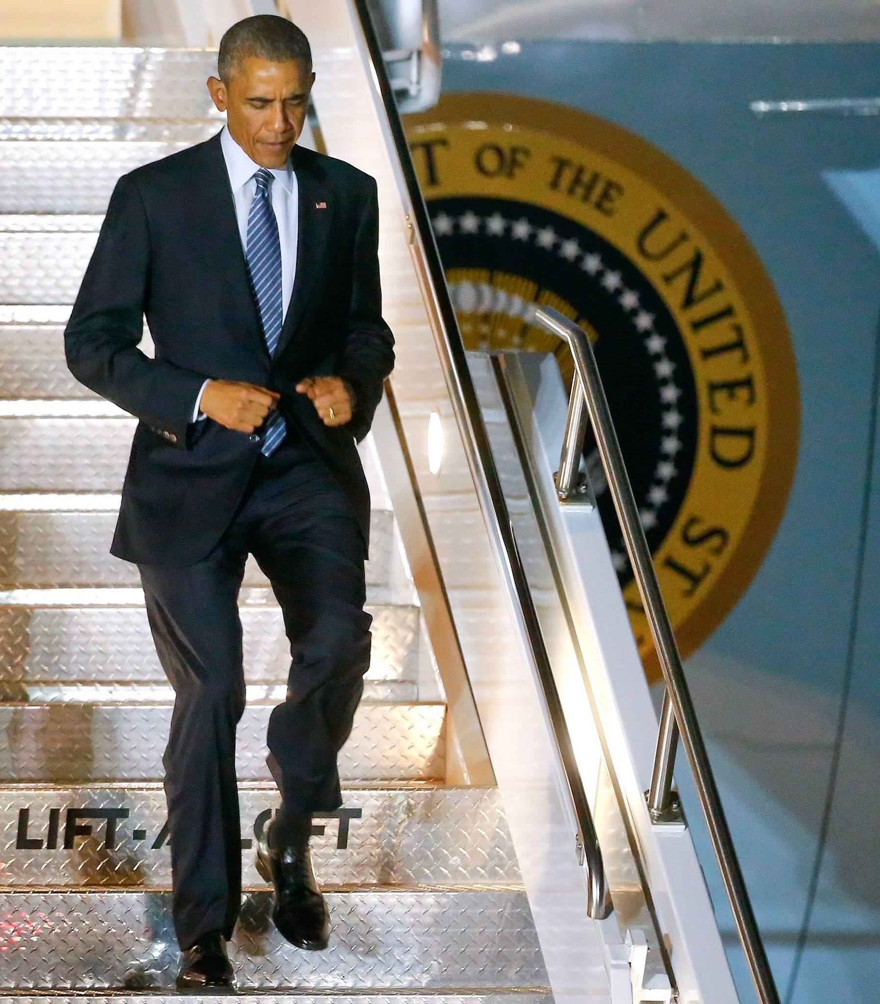 President Barack Obama jogs down the stairs from Air Force One after landing at Forbes Field on Jan. 21, 2015. Obama spoke at the University of Kansas the next morning.