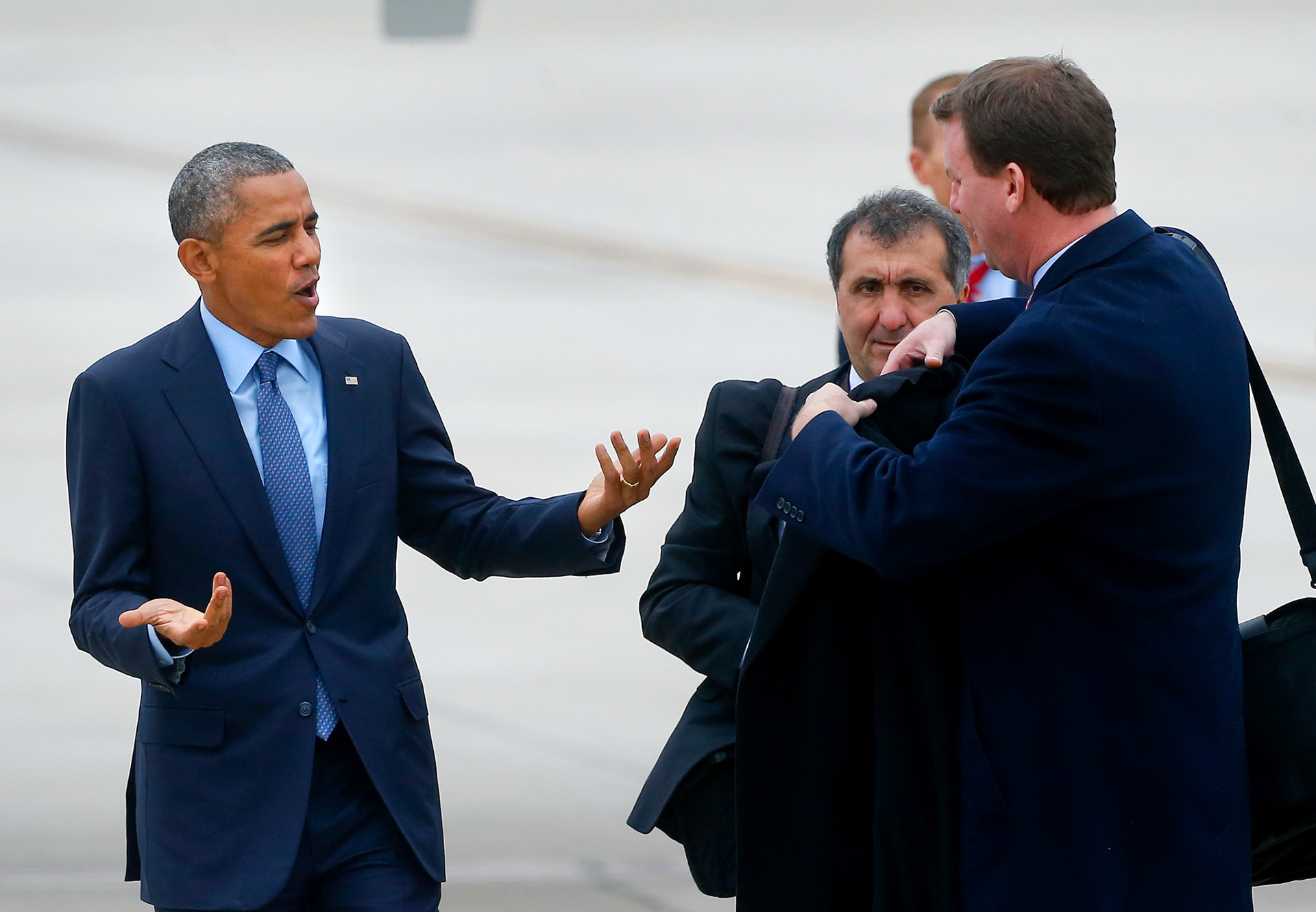 President Obama asks for his coat back after feeling the cold air at Forbes Field in Topeka, Kan. on Thursday Jan. 22, 2015, prior to his departure on Air Force One. The President spoke at the University of Kansas in Lawrence, Kan., Thursday morning.
