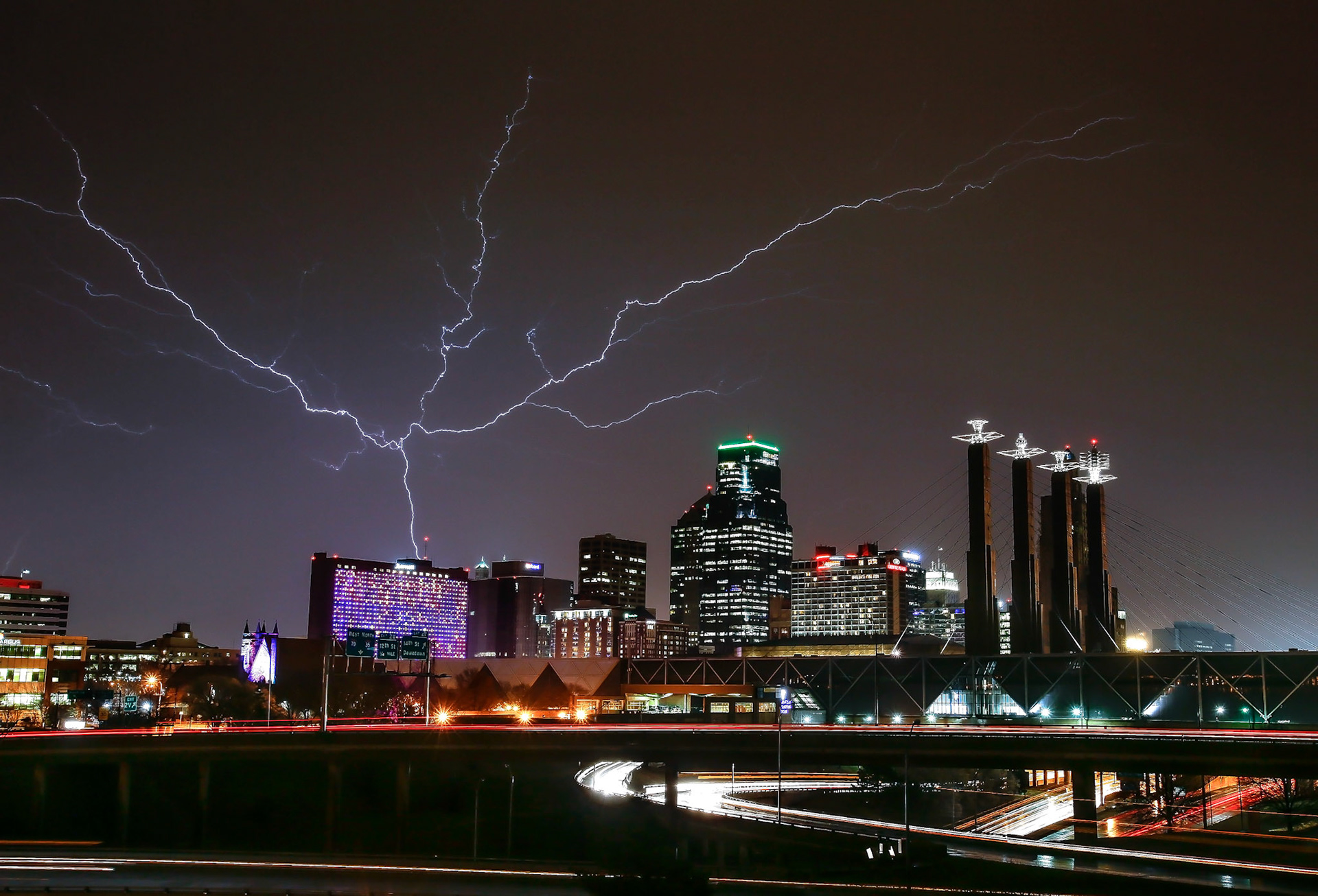 Lightning stretches out over the Kansas City skyline while a line of storms moved across northeast Kansas. (Chris Neal/The Capital-Journal)