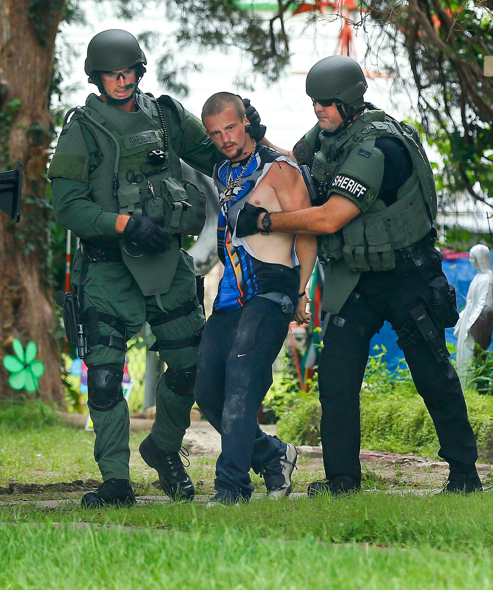 Law enforcement officials arrest Jesse Lee McCormic after an hours long standoff on July 21, near Southwest 16th and Fillmore.