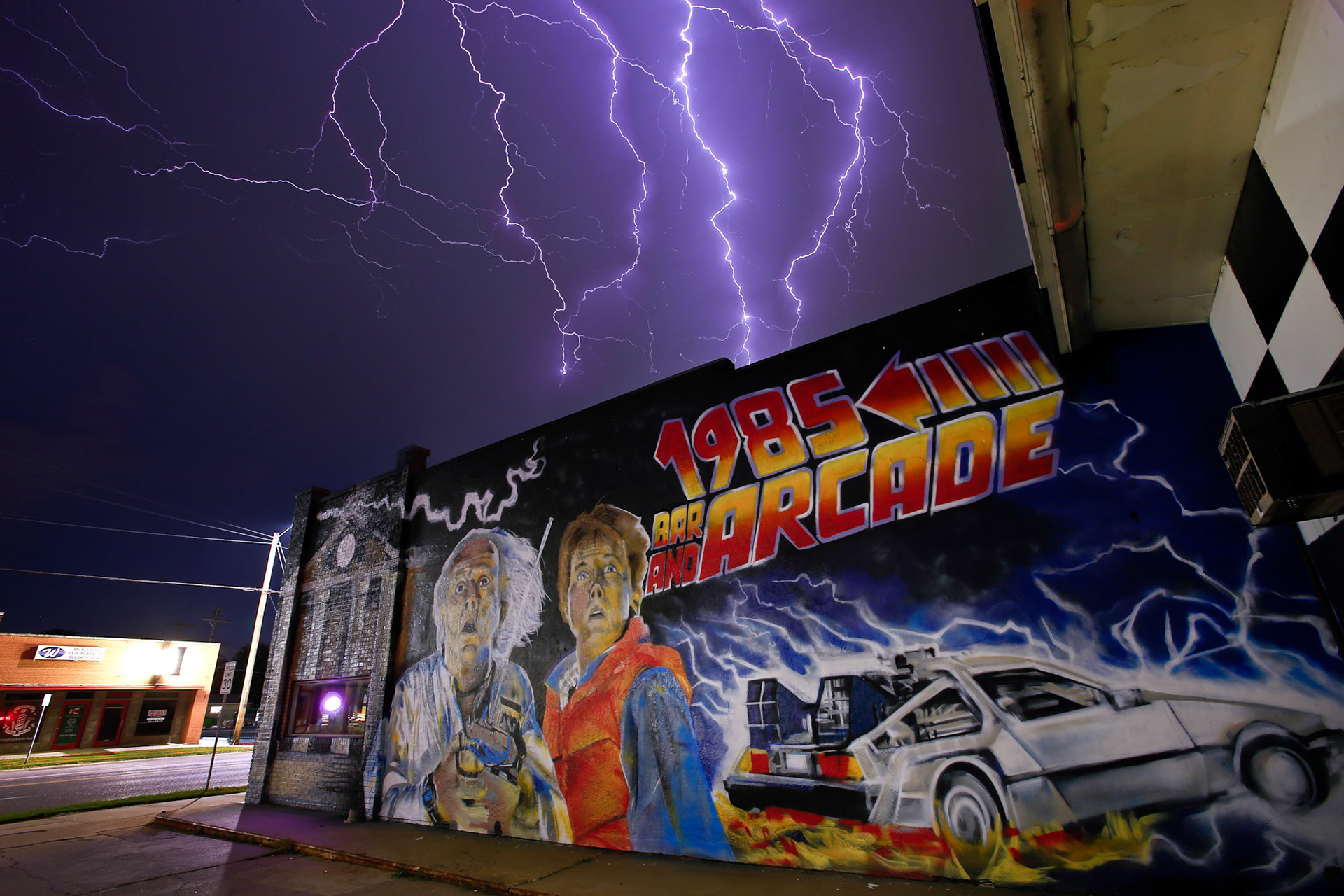 In this image made from nine separate lightning photographs, bolts of lightning strike over the 1985 Arcade Bar and Grill at 1021 W. Maple in Wichita, Kan., on Saturday, June 15, 2019.  [Photo Illustration by Chris Neal/The Capital-Journal]