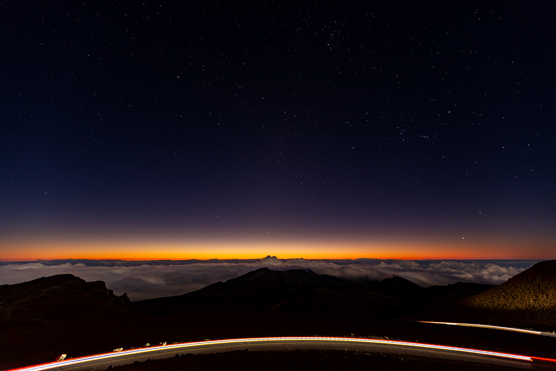 The sun rises over the clouds at the summit of Haleakalā National Park on Monday, August 3, 2016, on the Hawaiian island of Maui. 