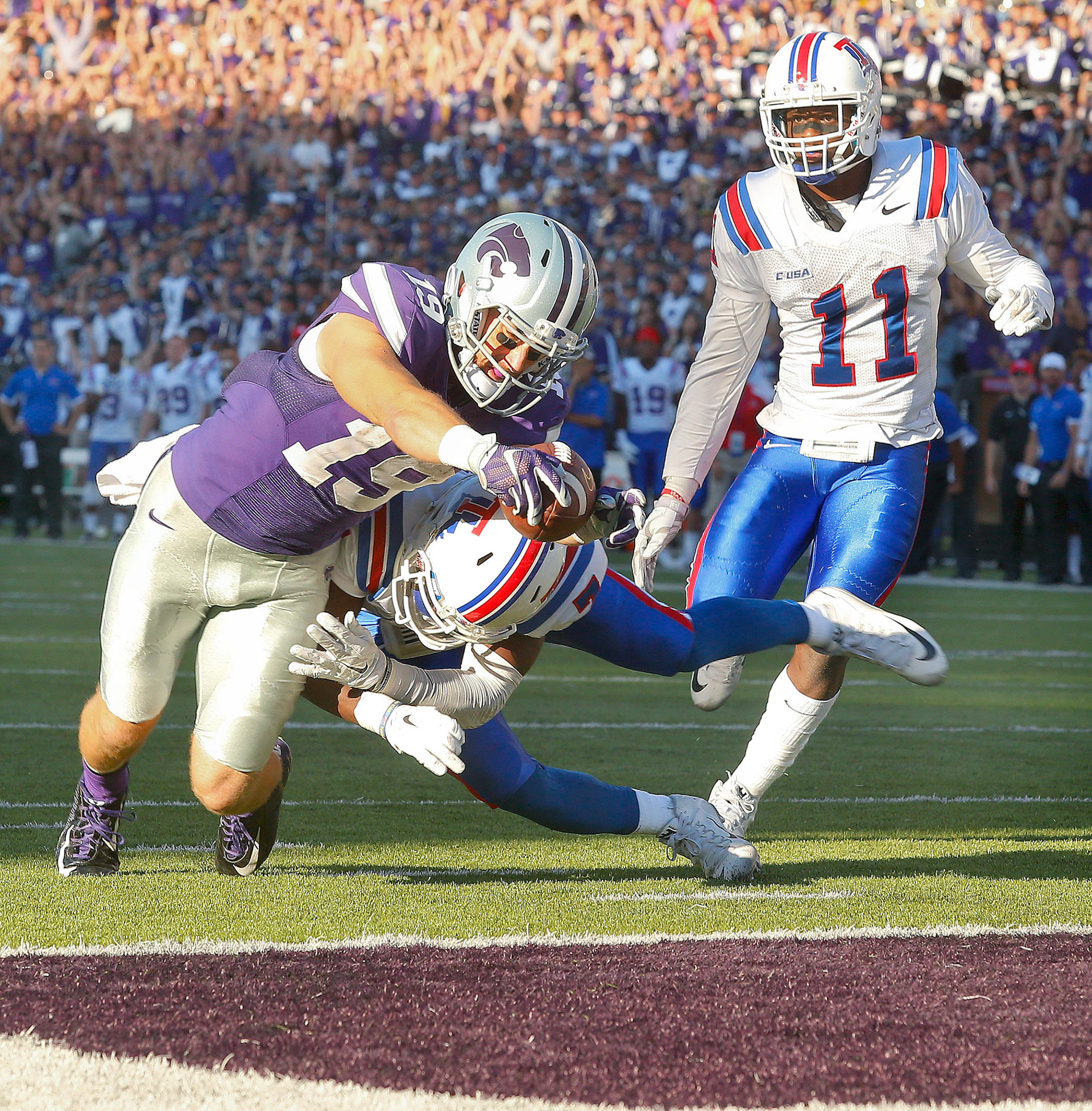 Kansas State's Kody Cook (19) makes the diving score for what ended up being the Wildcat's game winning touchdown during the third overtime of Saturday afternoon's game in Manhattan. The Wildcats defeated Louisiana Tech, 39-33.