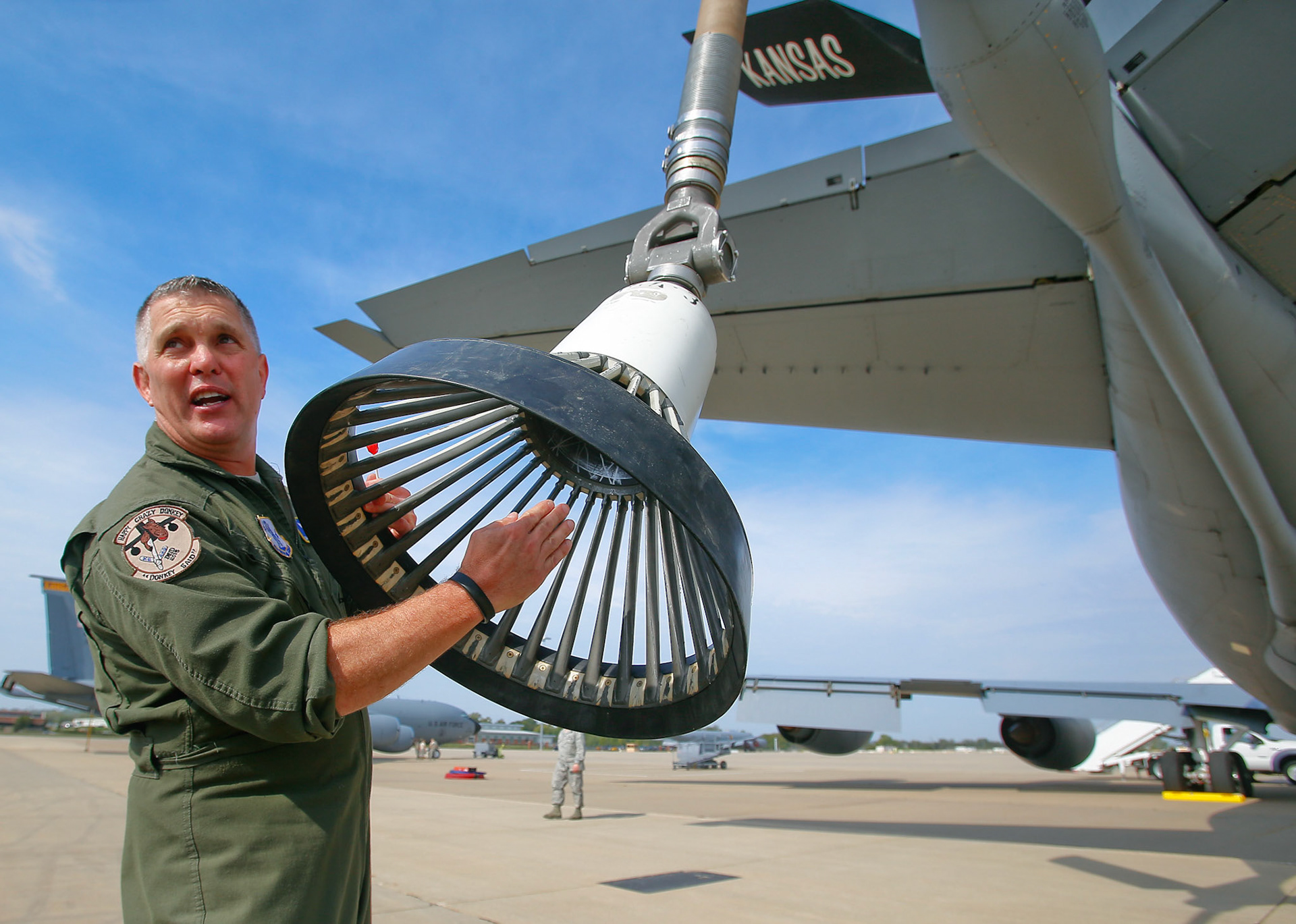 Boom operator Brian Dillon shows how the Blue Angels will retrieve the fuel from the KC-135 prior to a media refueling flight on Wednesday Sept. 23, 2015, at the Kansas Air National Guard's 190th Air Refueling Wing at Forbes Field in Topeka, Kan.