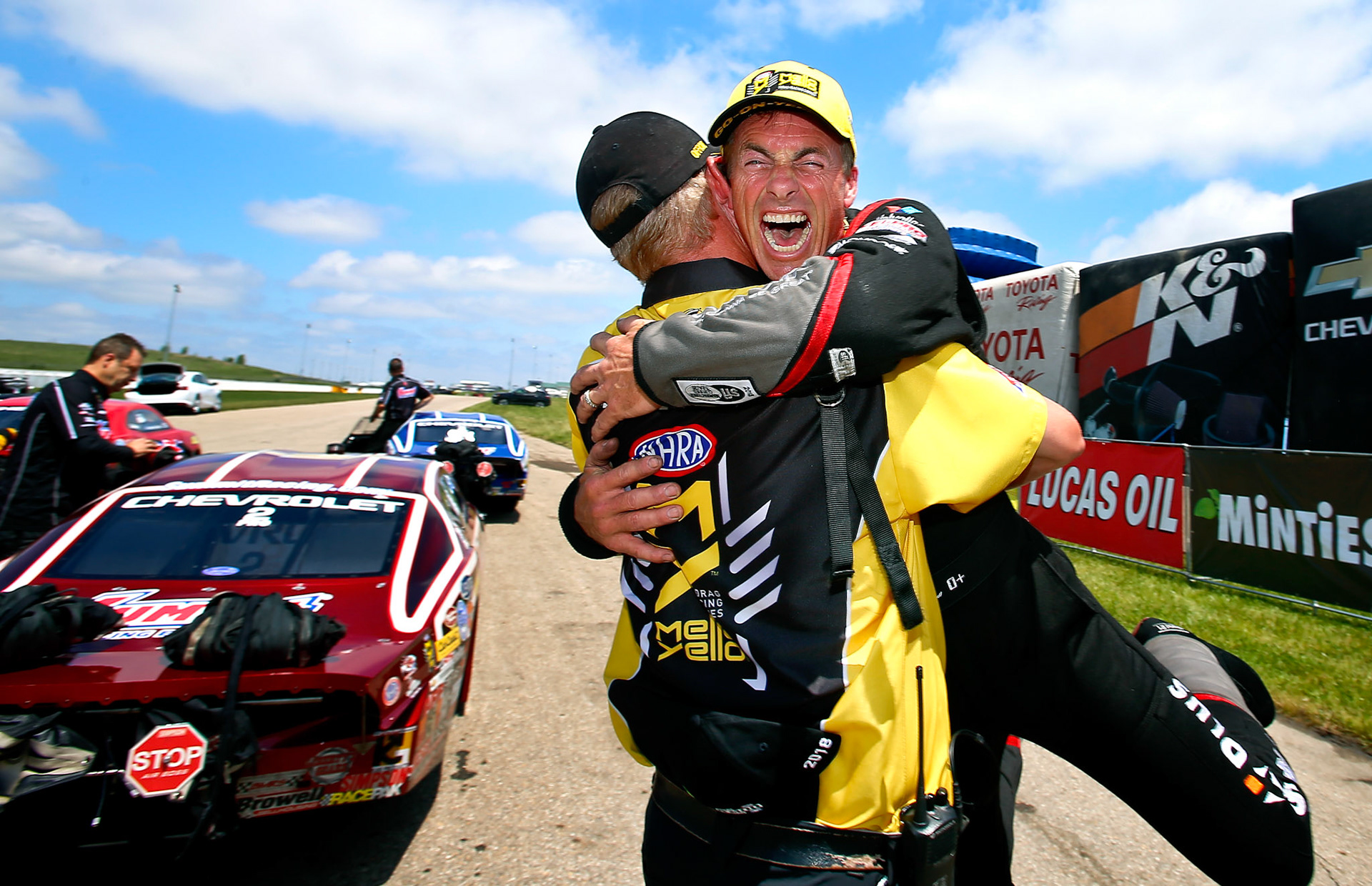 NHRA Top Fuel driver Clay Millican, right, yells in excitement while hugging the NHRA's Dave Kuschae after winning the Menards NHRA Heartland Nationals on Monday, May 21, 2018, at Heartland Motorsports Park in Topeka, Kan. Millican won the race by defeating Terry McMillen with a time of 3.727 at 332.59 mph. This image, taken by Capital-Journal photographer Chris Neal, won second place in the Kansas Press Association's  sports photography category in the daily division III circulation group.