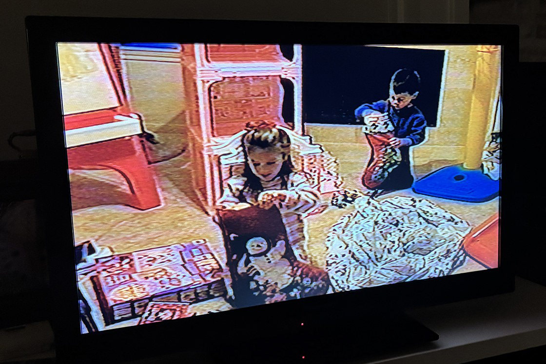 Oh the excitement of children delving into their Christmas morning stockings (snapshot taken as a VHS tape played)