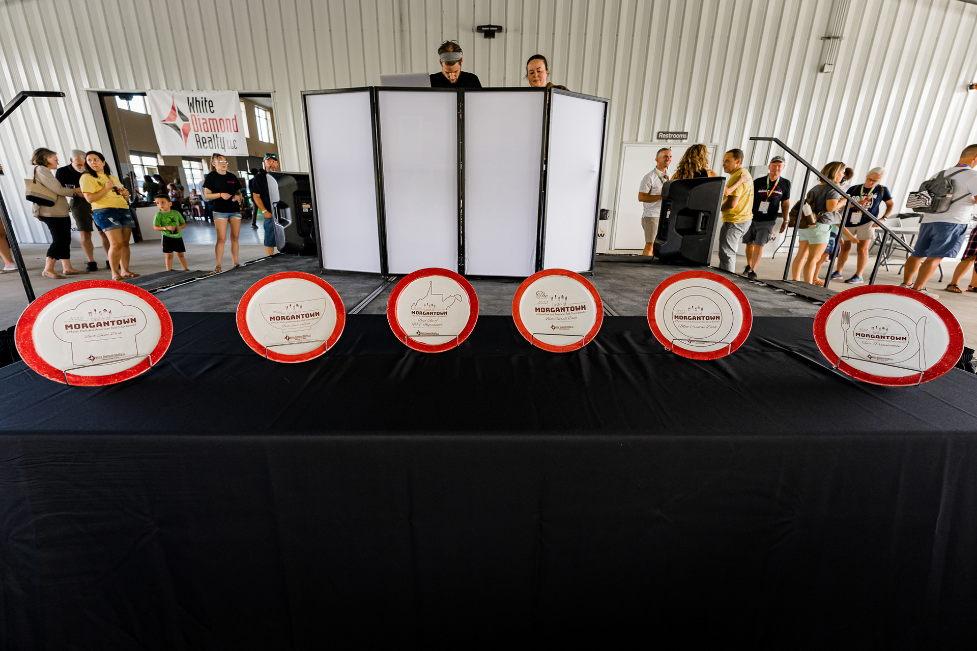2022 Taste of Morgantown Award Table at the event with all six awards. In order: Best Sweet Dish, Best Savory Dish, Best Use of West Virginia Ingredients, Best Overall Dish, Most Creative Dish, and Best Presentation. PHOTO CRED: Grayson Hall Photography