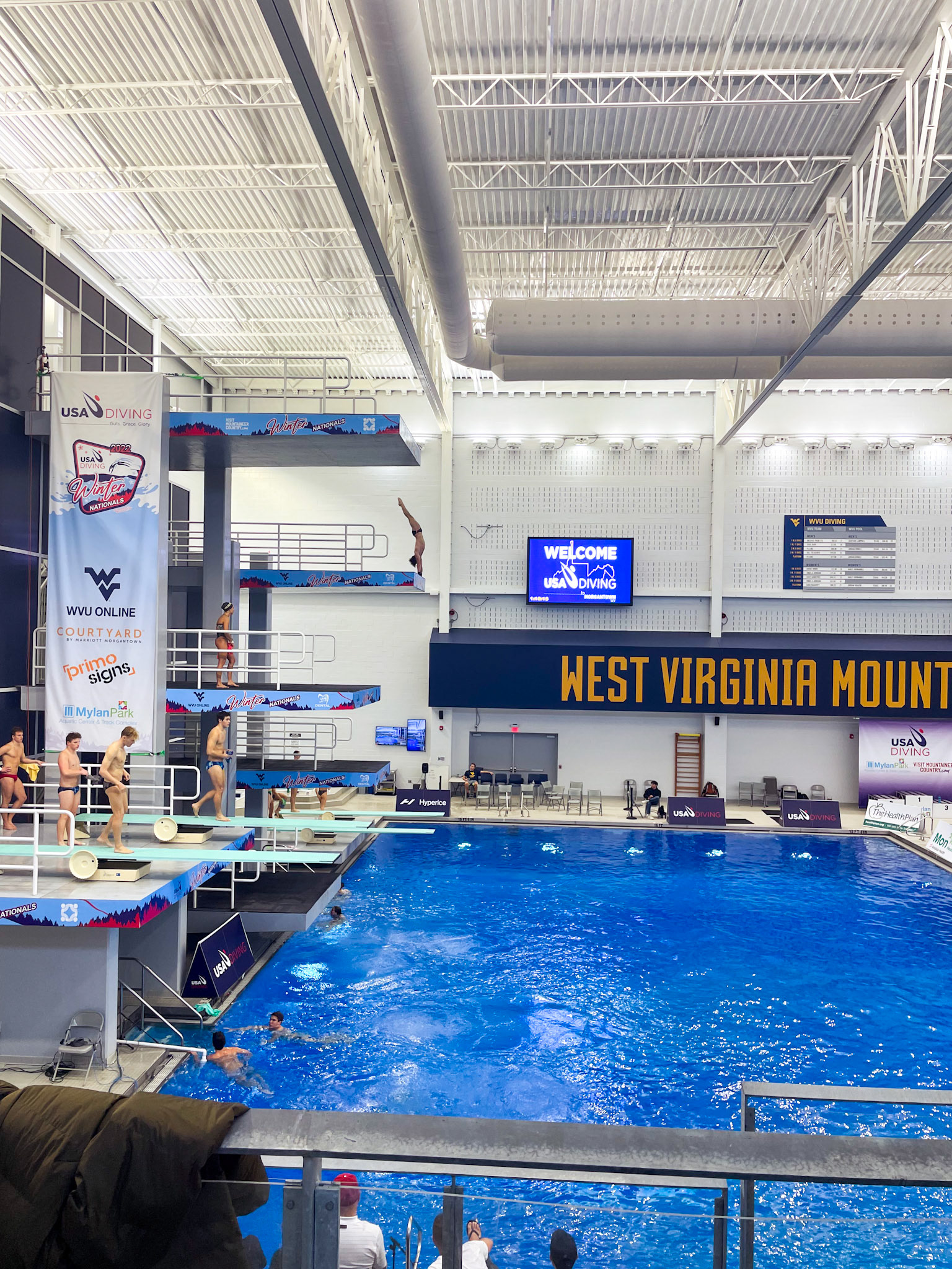 Banner and Platform Wraps on The Aquatic Center at Mylan Park's Diving Tower Side View with Diver Performing an Arm-stand at 8m