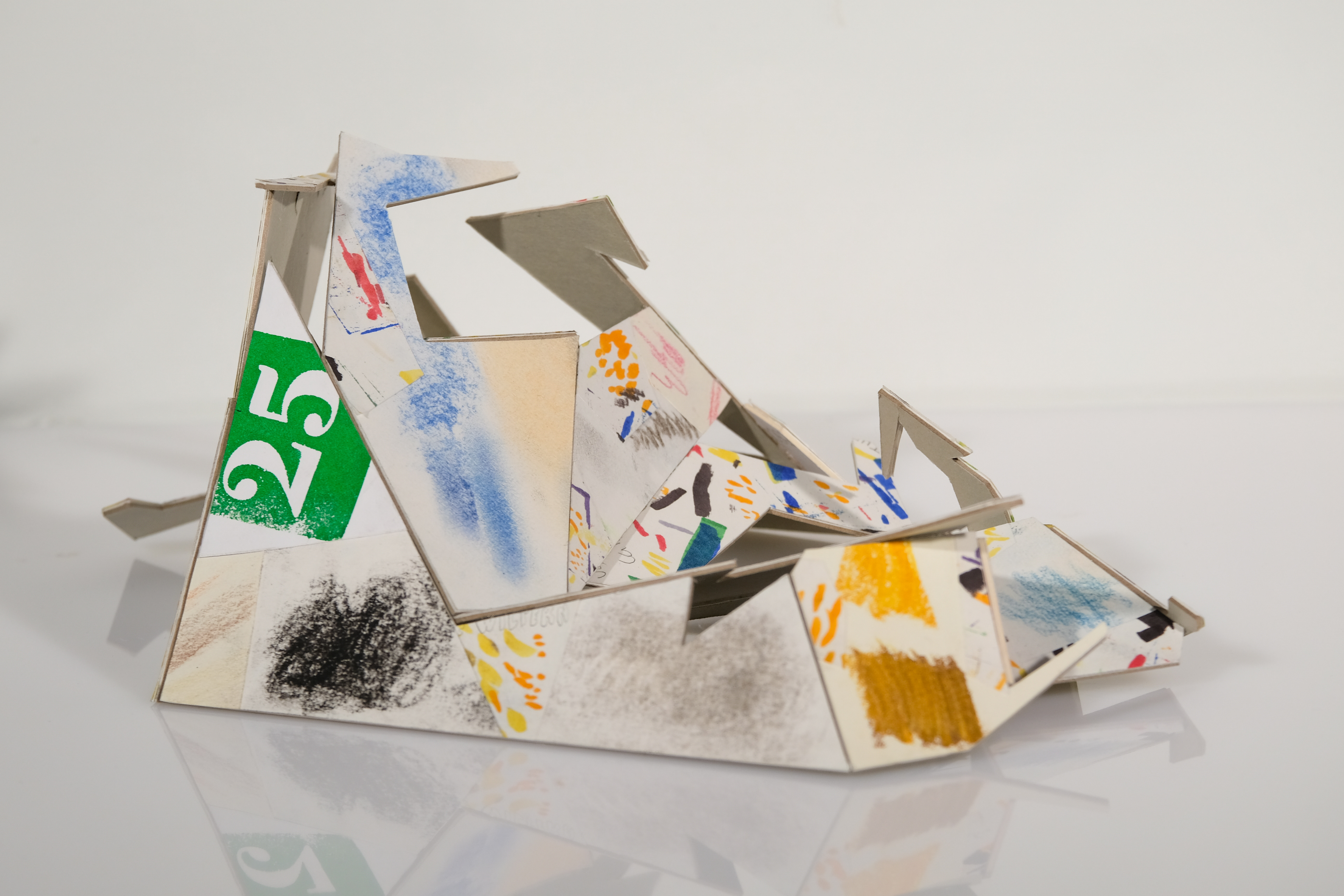 Sculpture with art project scraps and mounting board.