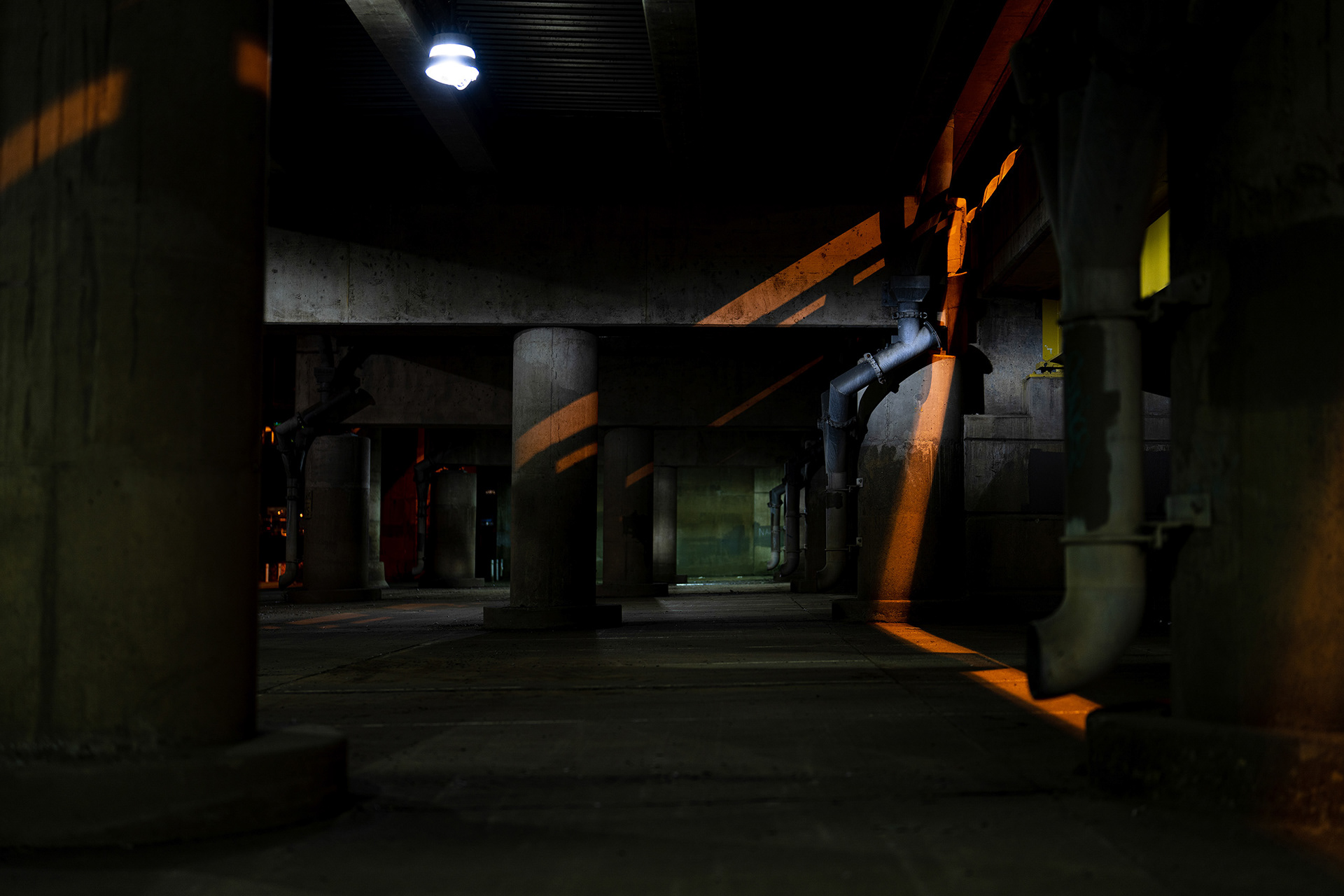 Dramatic lines of light illuminate underpass tunnel in photograph by Bucchianeri.