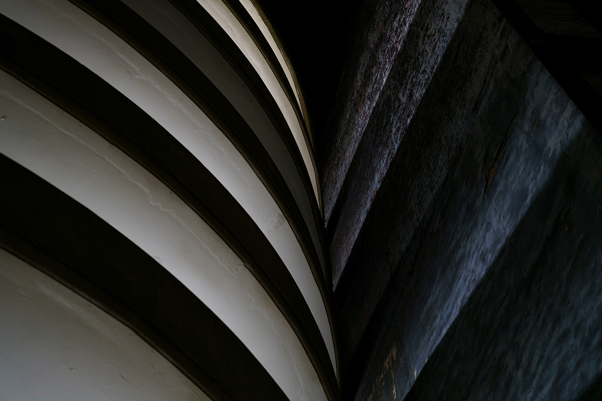 Parking garage lines conform in geometric patterns at night by Bucchianeri.