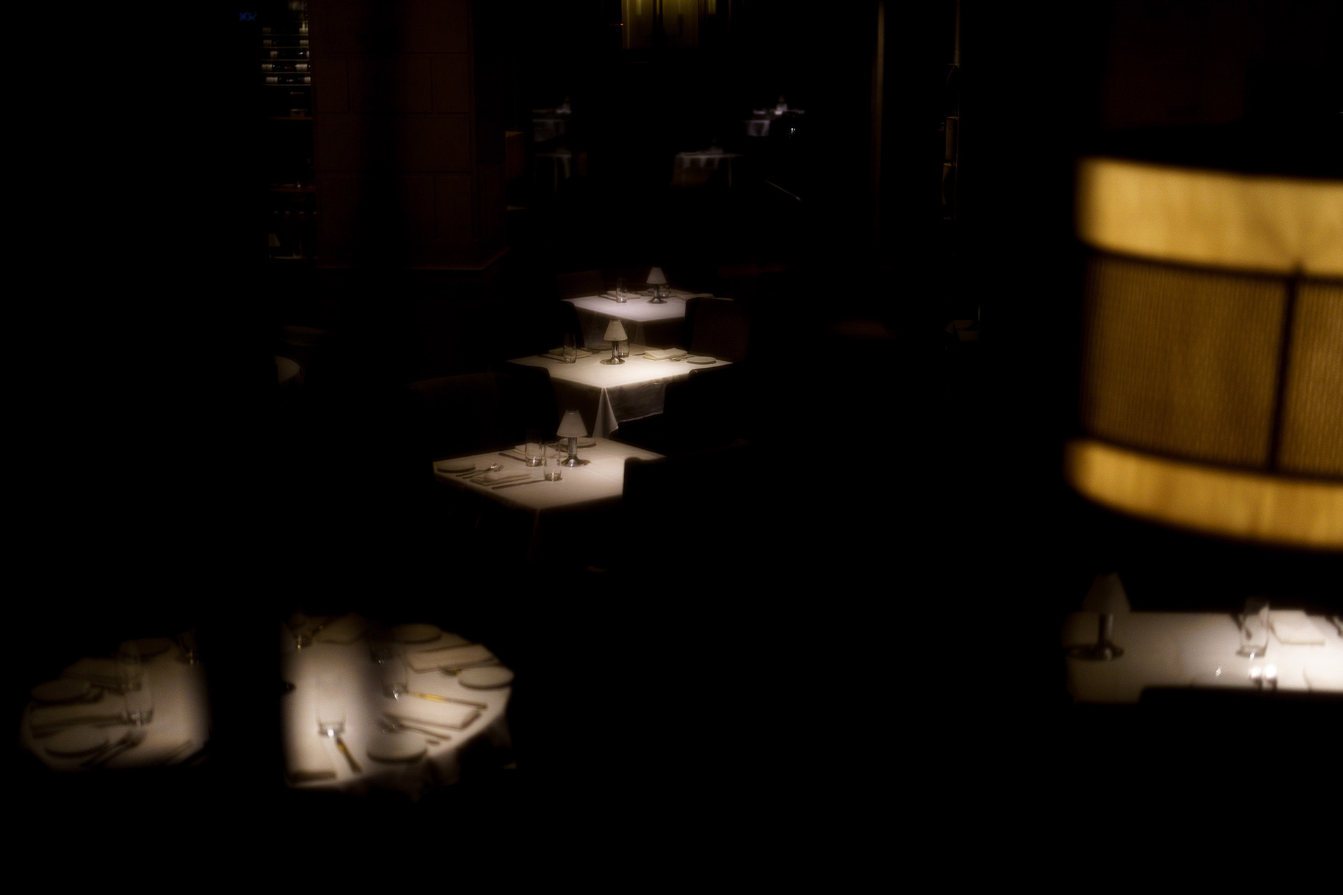 Minimal restaurant interior with a single table under soft light. Photograph by Ryan Bucchianeri, professional photographer.