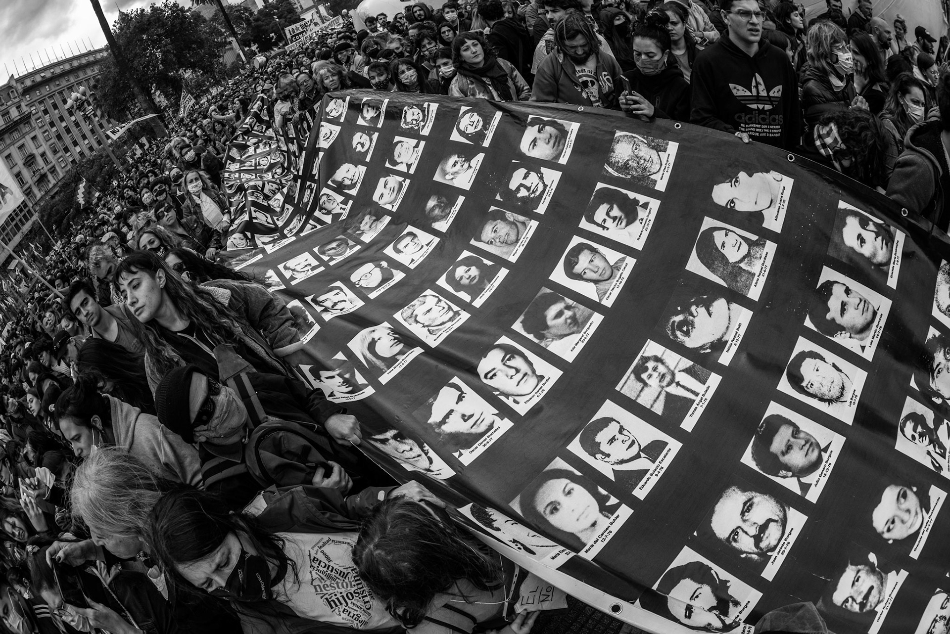 "Memory Flag" More than 100 people carry a very long flag showing the faces of the disappeared during a March 24th protest.