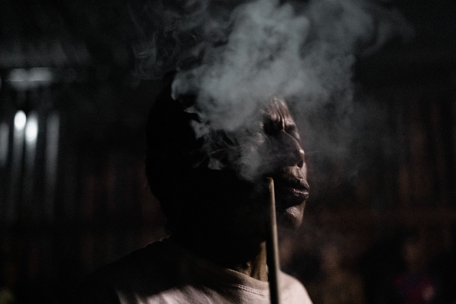 A shaman smokes and prays during Arapyau, the Guarani New Year. This day, which symbolizes the beginning of spring, is marked by ceremonies that encompass the revitalization of spirits and nature, laying the foundation for the forthcoming season of new plantings.