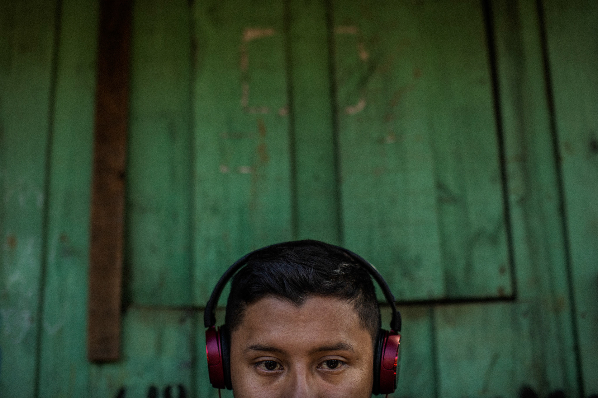 Anthony Karai, 21, teaches online Guarani language classes from his home in Tekoa Pyau Village, located in the North Zone of São Paulo. The classes are targeted towards a group of non-indigenous individuals who pay a monthly fee for the lessons. Karai, a historian, intellectual, and Guarani teacher, is dedicated to preserving and sharing the rich cultural heritage of the Guarani community.