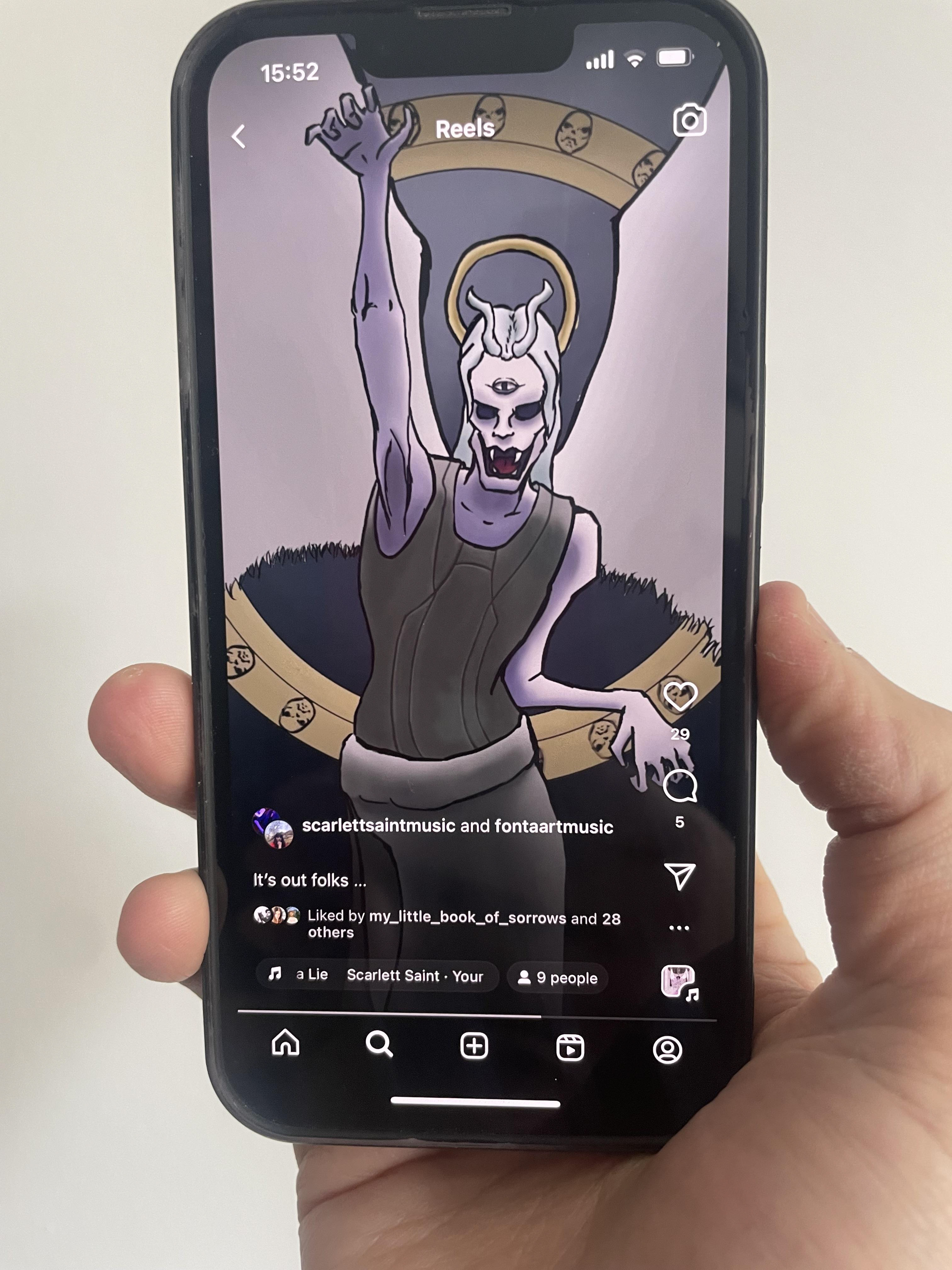 Picture of a smartphone showing an instagram. The artwork used is a demonic angel with silver hair raising his right arm in a threatening way. He's got a third eye on his forehead, black eyes and fangs. In the background there is a golden wheel with faces sculpted on it.