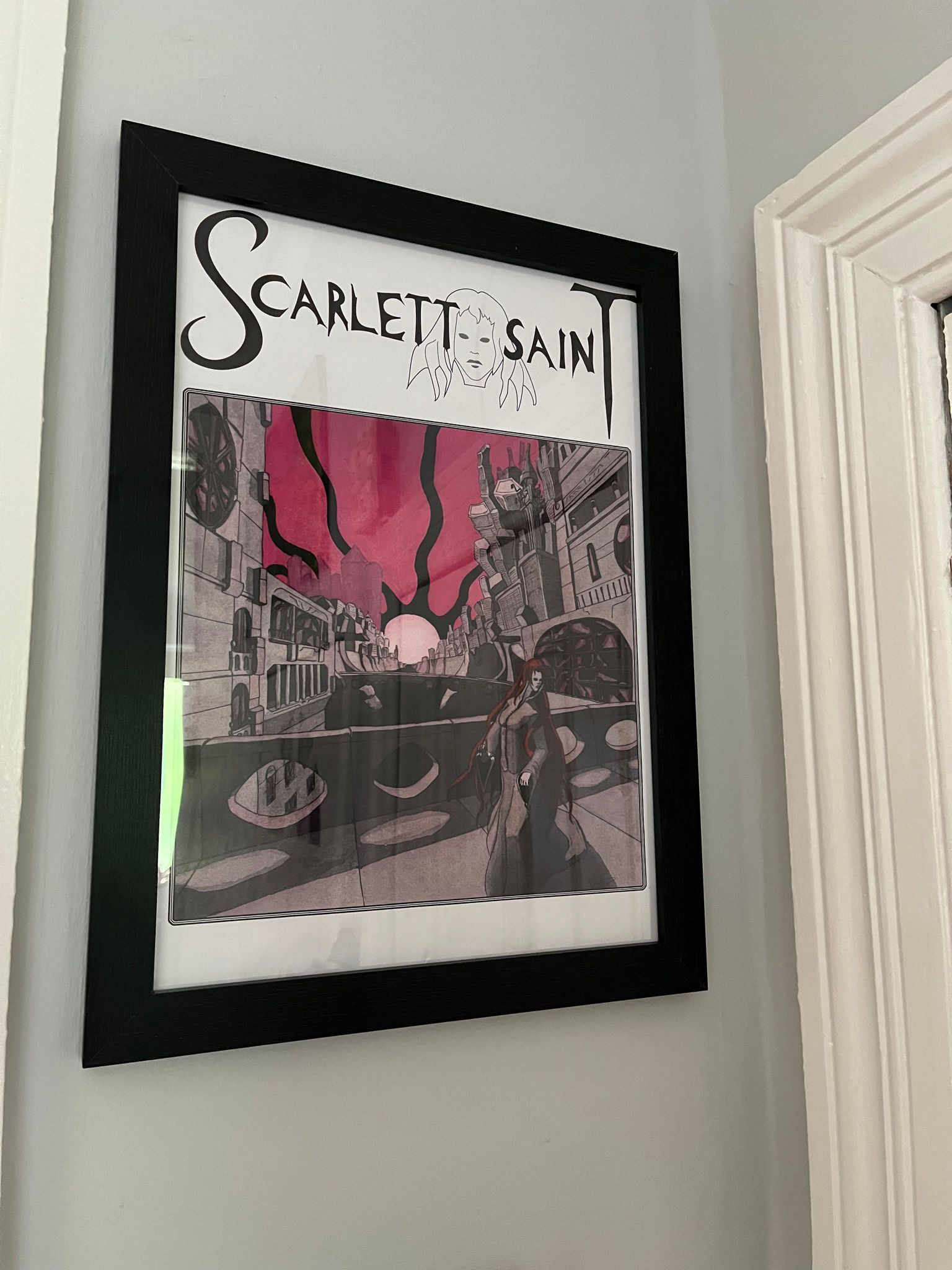 Framed Locked in this City poster put on a wall