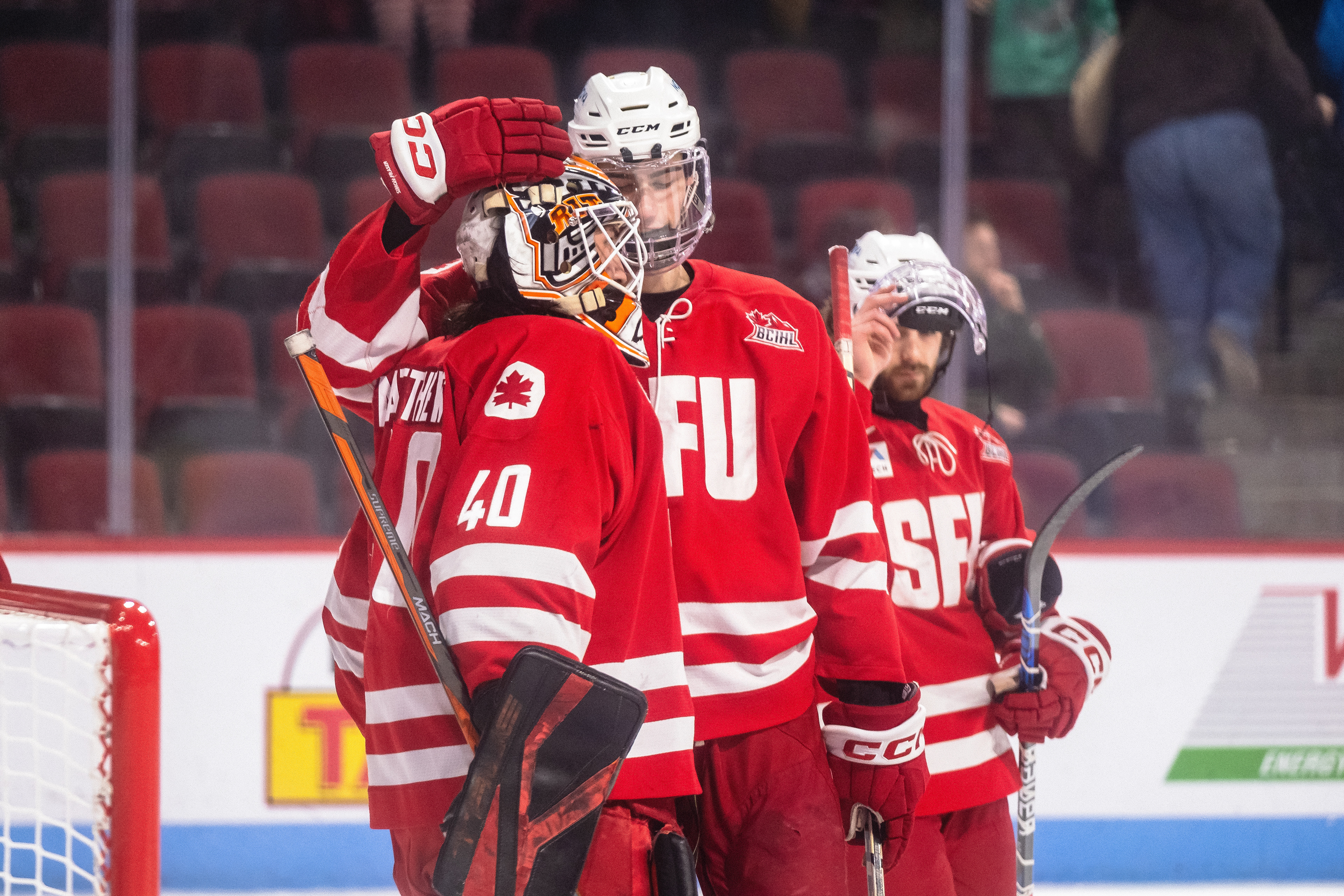 SFU at Boston University 01.05.24 | Forward Garrett Hilton and goaltender Kolby Matthews share a hug after falling to the BU Terriers in the shootout.