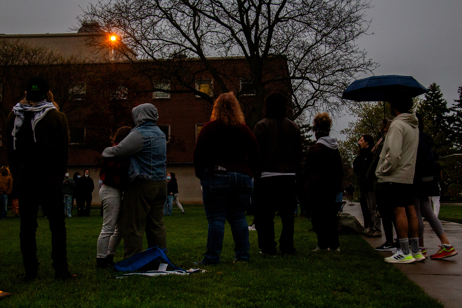 Gaza solidarity protestors hug and gather together in song at the beginning of the Passover Ceremony.