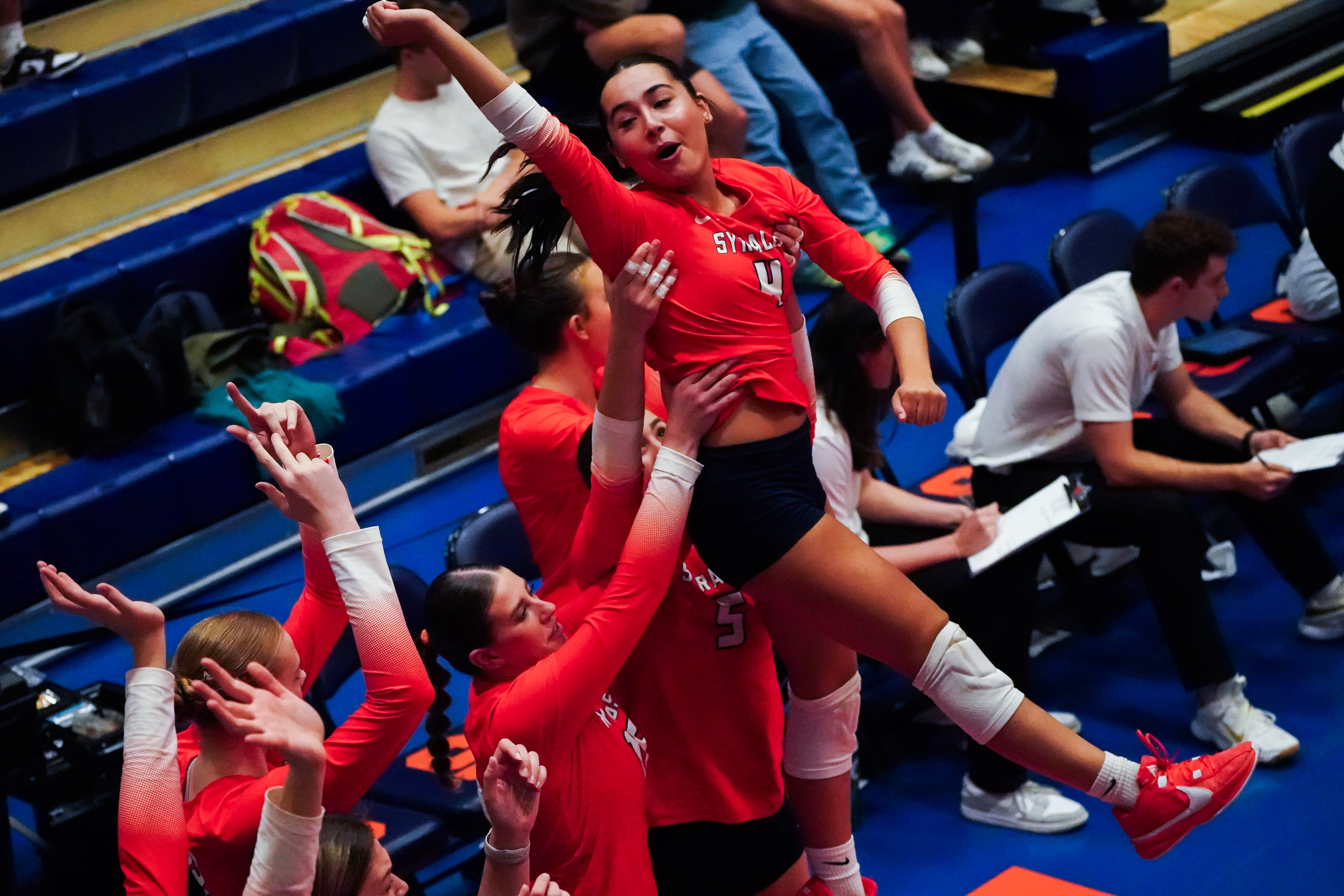 Syracuse libero Emma Ortiz is lifted into the air by teammates after winning a set against Virginia on October 23, 2024.