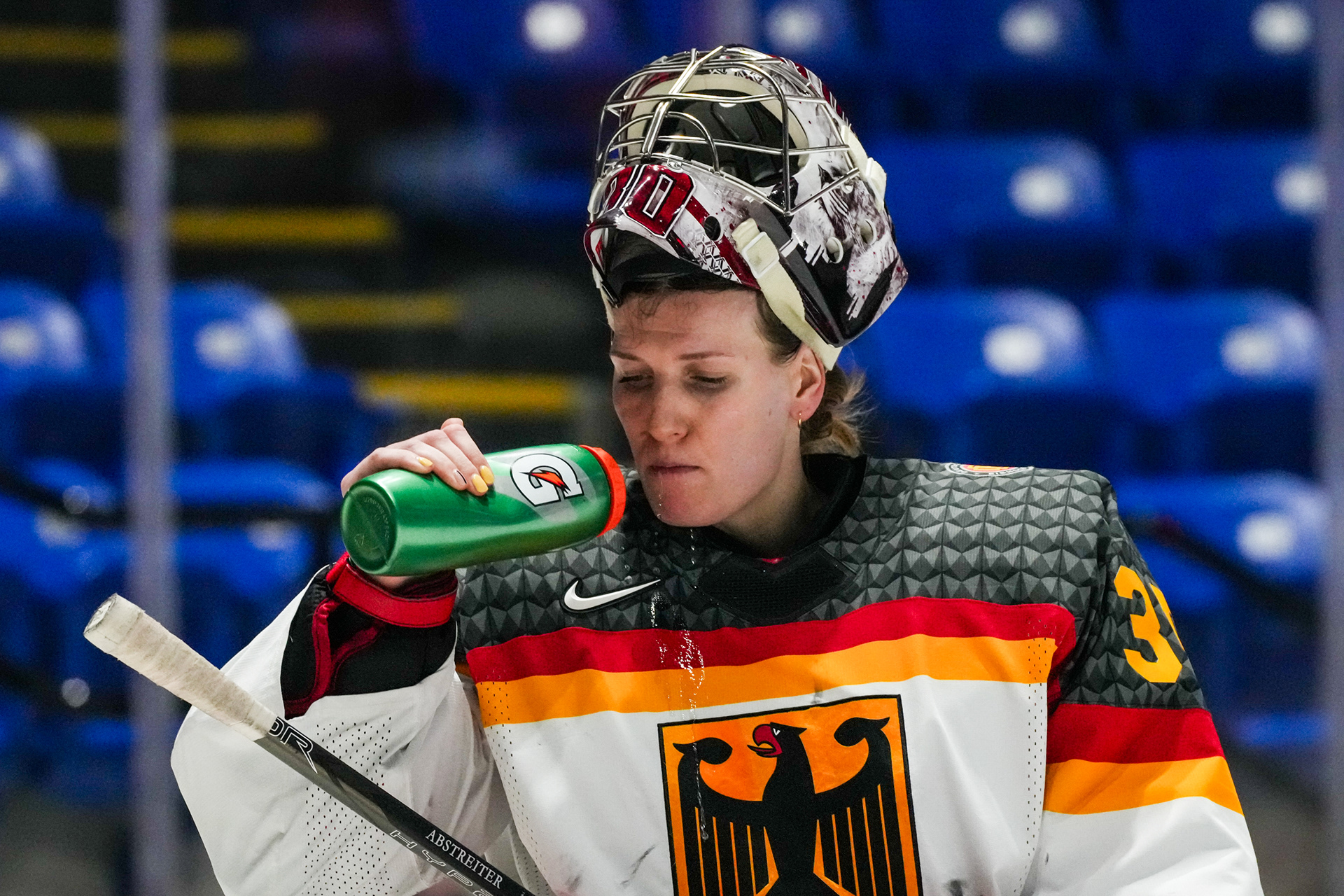 Sandra Abstreiter flashes her yellow, Germany colored nails while having a water break during the Sweden-Germany preliminary round game of the IIHF Women’s World Championships at the Adirondack Bank Center on April 7, 2024.