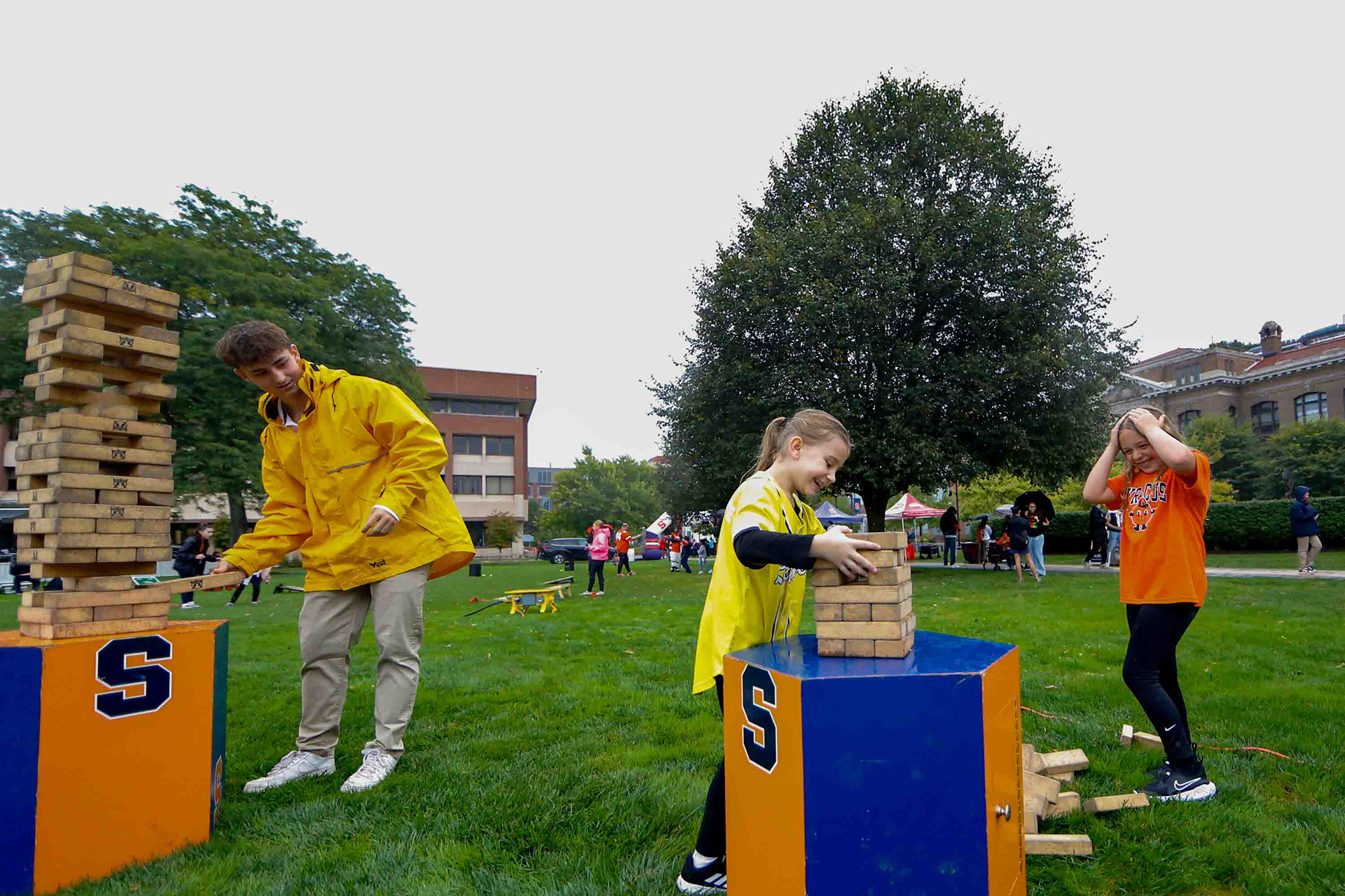 Young Syracuse fans react to a fallen Jenga tower during the Cuse on the Quad event on the Syracuse Quad before the home opener against UConn.