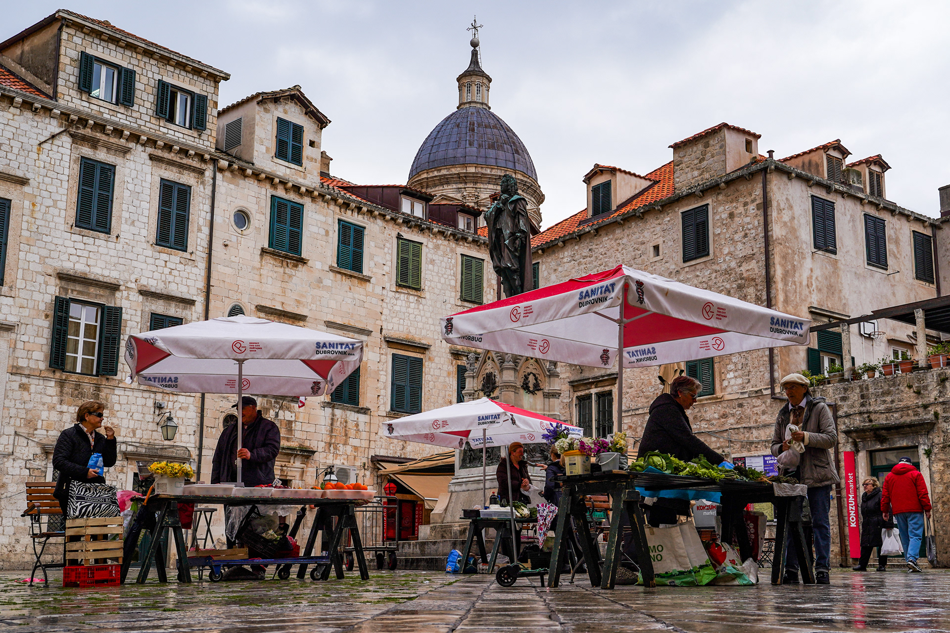 Tourists browsing vendor stalls in Dubrovnik help sustain local livelihoods