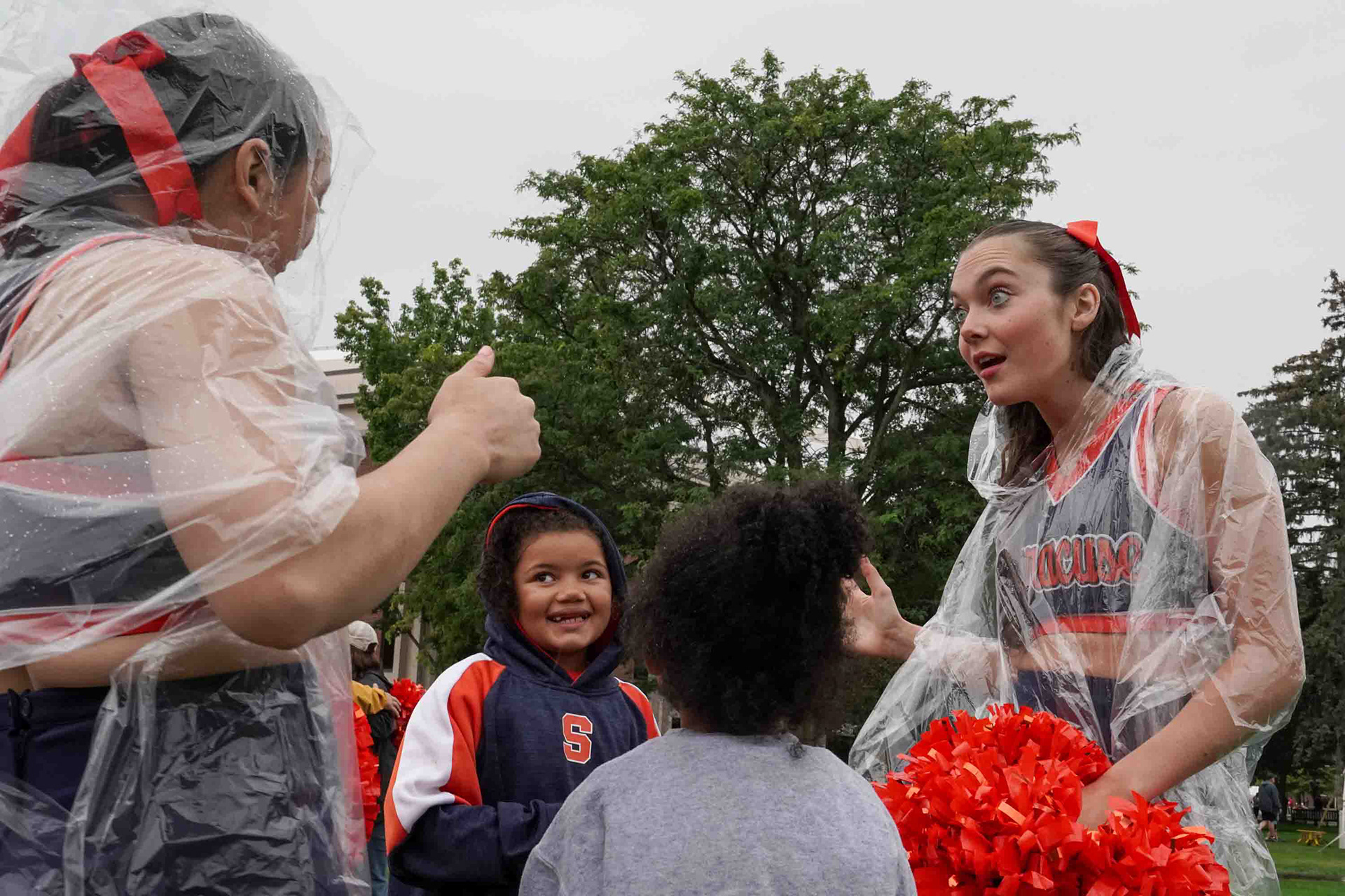 Syracuse cheerleaders interact with young fans before the home opener during Cuse on the Quad.
