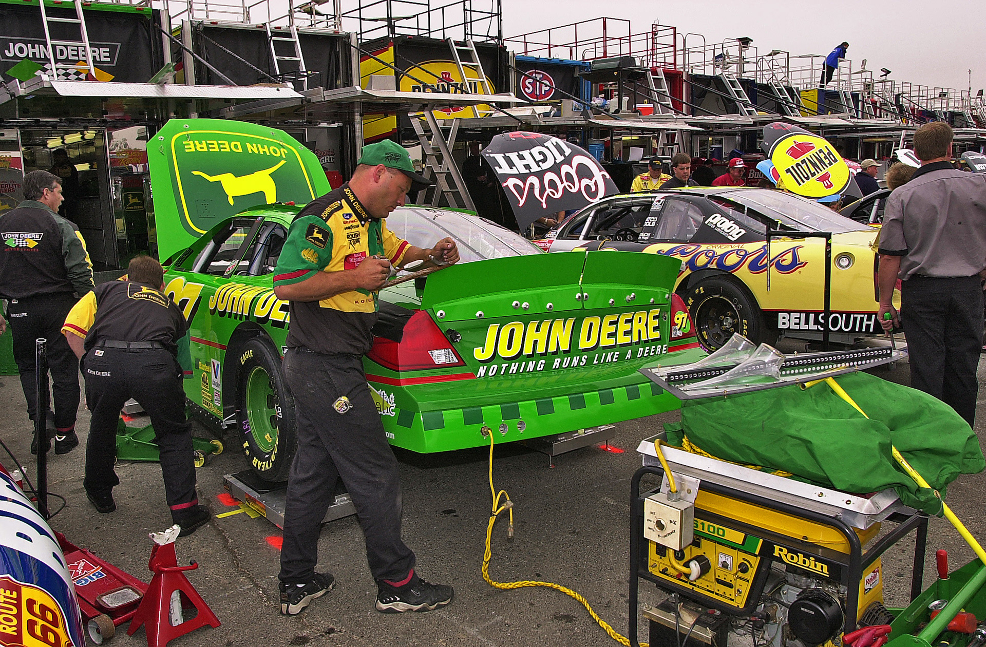 Chad Little's John Deere #97 Ford Taurus getting a rear spoiler shave...  ©  IAN DONALD