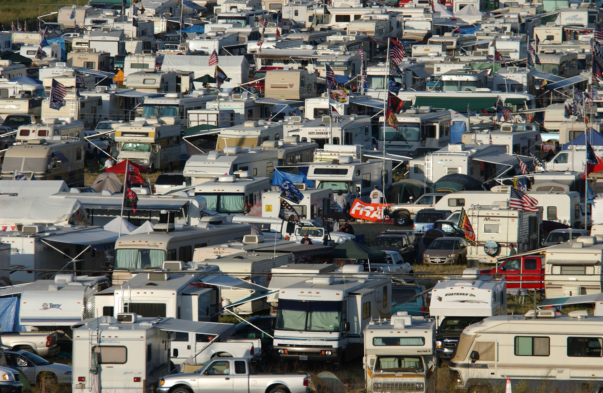 "The Jungle" - NASCAR camping area in a field opposite the Sears Point track in 2000. For most it was a regular annual pilgramage. The campers would start to arrive a couple of days before the NASCAR event to ensure the best locations - and they enjoyed a great cameraderie - but by nightfall it could get a little "rowdy". Even the Sonoma County Sheriff's Dept. were a little tentative when going in there...  ©IAN DONALD