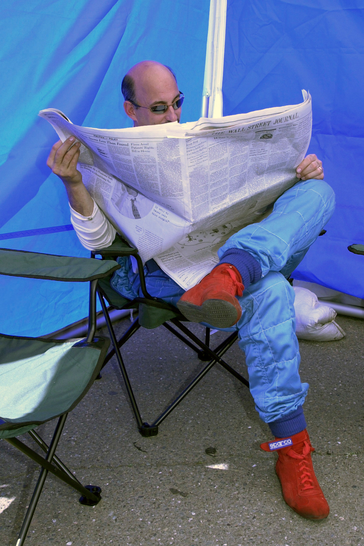 3-time Indy Car Champion - Bobby Rahal brought his Chevron sports racing car to a CSRG event in CA. I ran across him reading the Wall Street Journal in the back of his tent while his crew set up the car...  ©  IAN DONALD