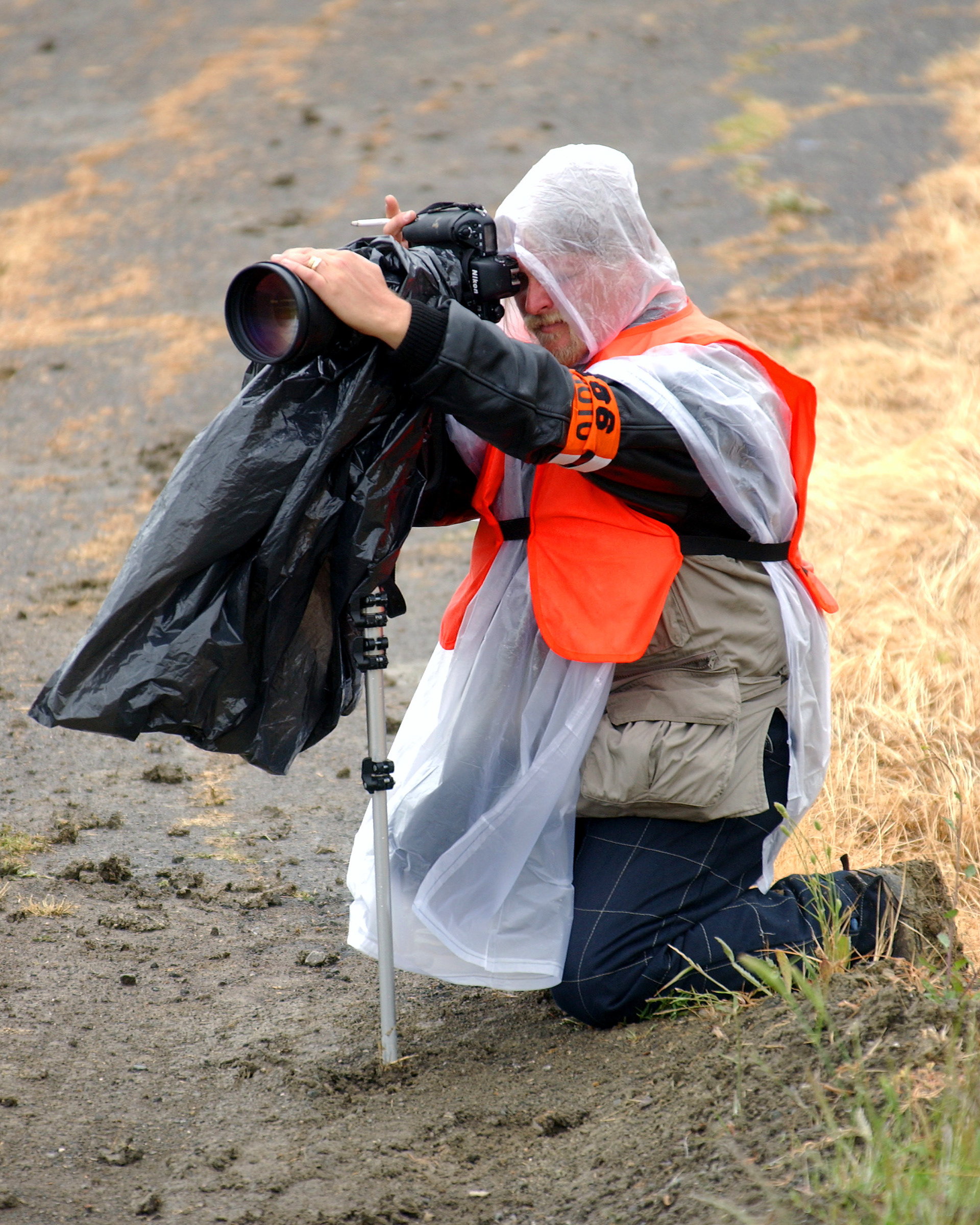 Sonoma's Track Photographer Chucke Walkden wrapped for rain at Sonoma.  © IAN DONALD