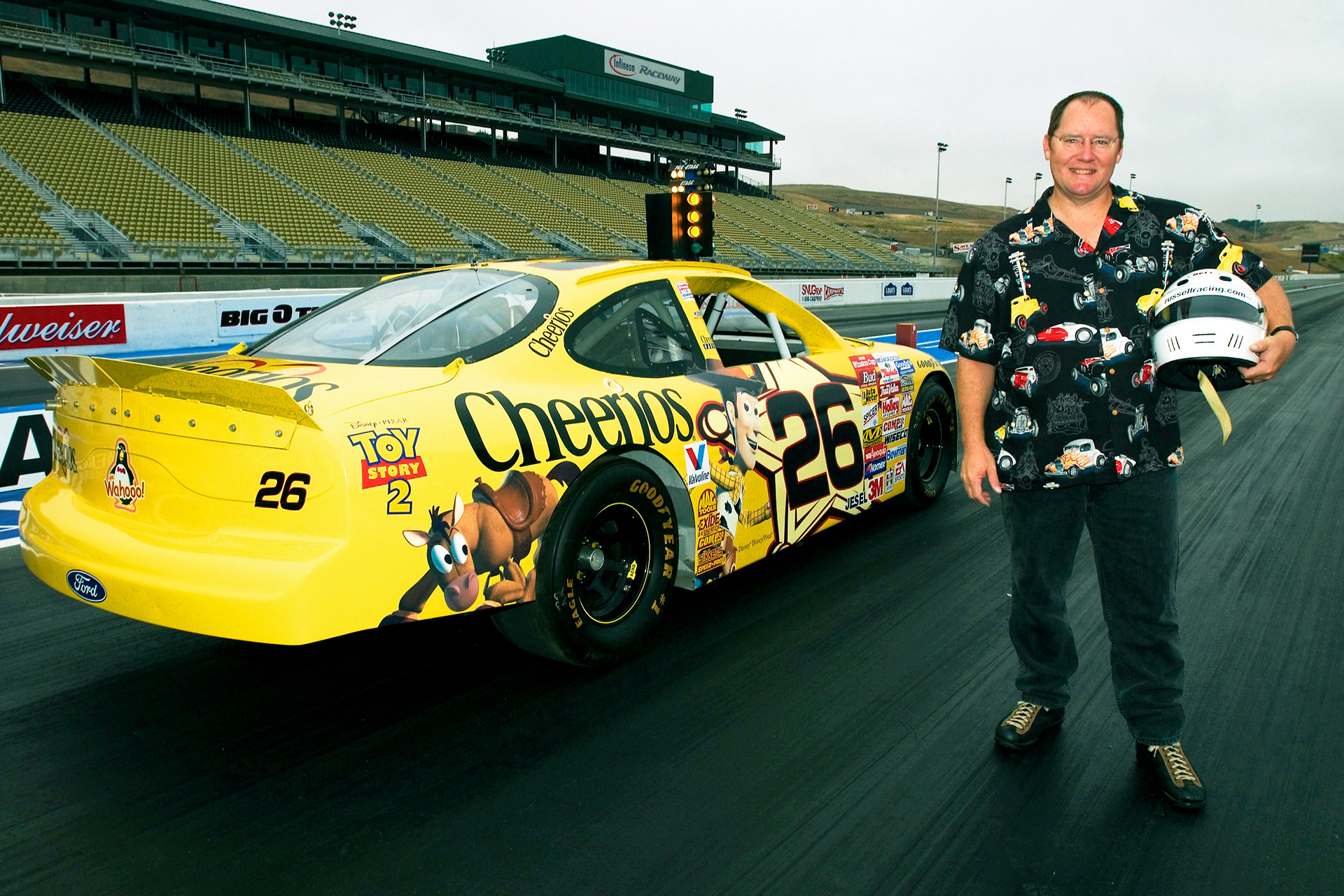 Director of the "Cars" & "Toy Story 2" movies - John Lasseter - with his NASCAR racer on the Sonoma Drag Strip.  © IAN DONALD