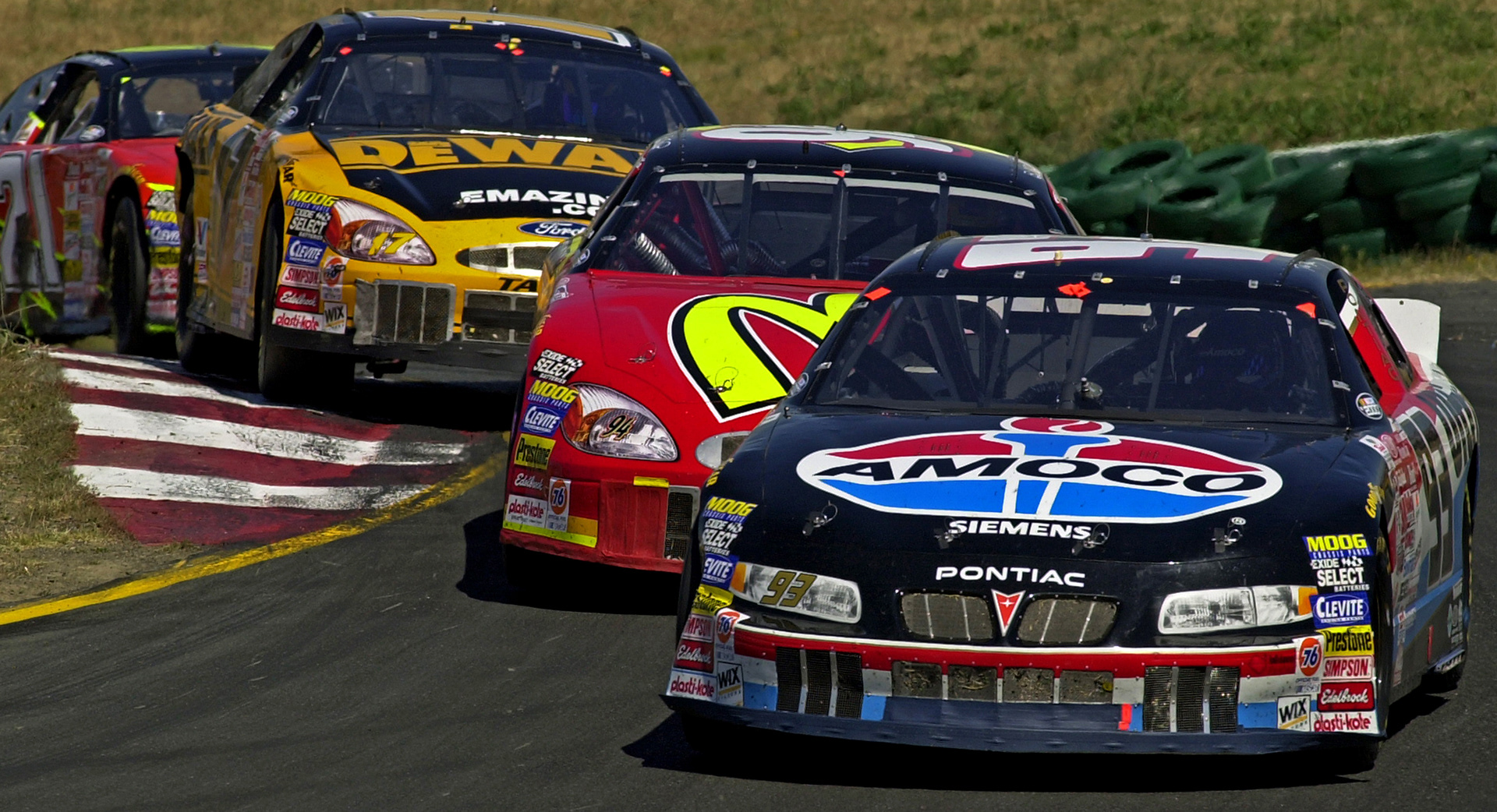 2000 - Close racing in Turn 2 at Sonoma - Bill Elliott in the red McDonald's Ford chasing the #93 Amoco car of Rookie, Dave Blaney......  © IAN DONALD