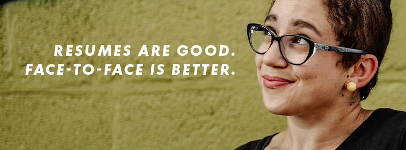 Becky, a bi-racial young woman with pixie-cut hair and black shirt, is seen looking towards the sky while smiling in front of a graphic-style mural. Written on the image, "Resumes are good. Face-to-face is better."