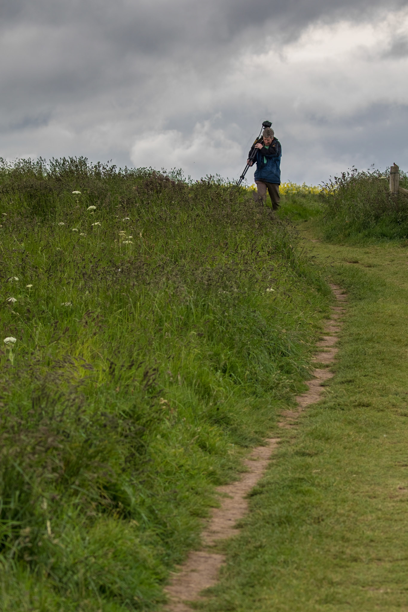 Beware - Photographers About!  I was composing my picture to include the leading line of the path and the stormy sky above, thinking all I need is something else in the picture to draw the eye to the horizon, when, right on cue, a photographer appeared, struggling with his tripod and camera.  Perfect!